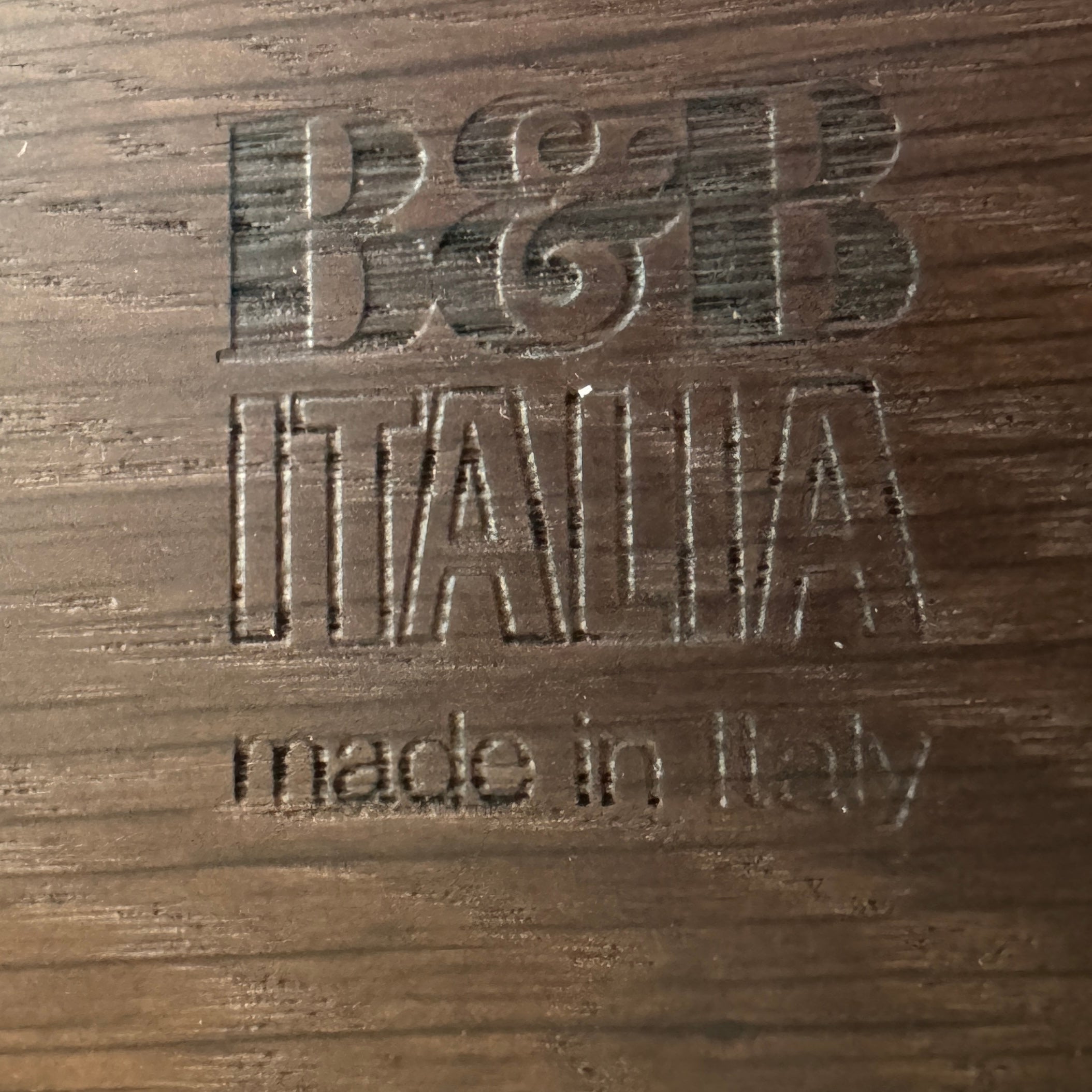 A modern luxury, rectangular wooden B&B Italia Luis Bench with angled metal legs by B&B Italia, shown on a plain white background and inspired by the refined aesthetic of Antonio Citterio.
