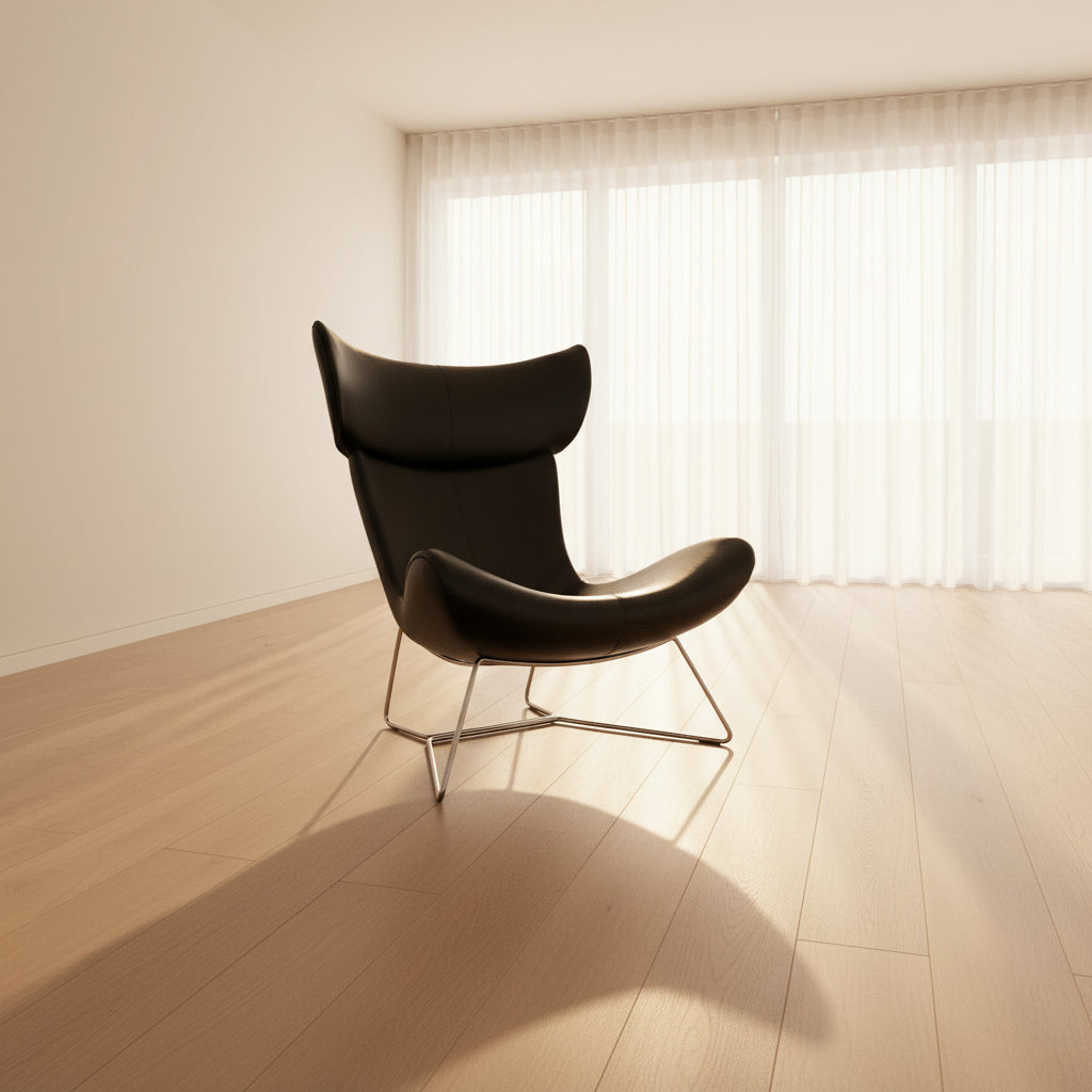 The BoConcept Imola Armchair by BoConcept is a modern black designer lounge chair with a curved leather seat and backrest, supported by slim metal legs, shown against a plain white background—an iconic piece inspired by the original Imola design.