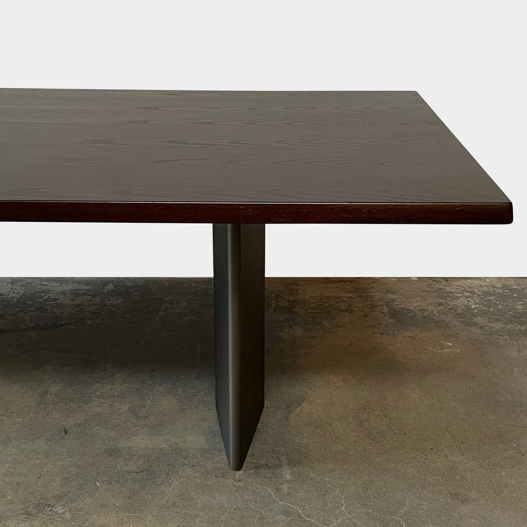 A Minotti Morgan dining table, dark brown with a smooth surface and angled legs, isolated on a white background.