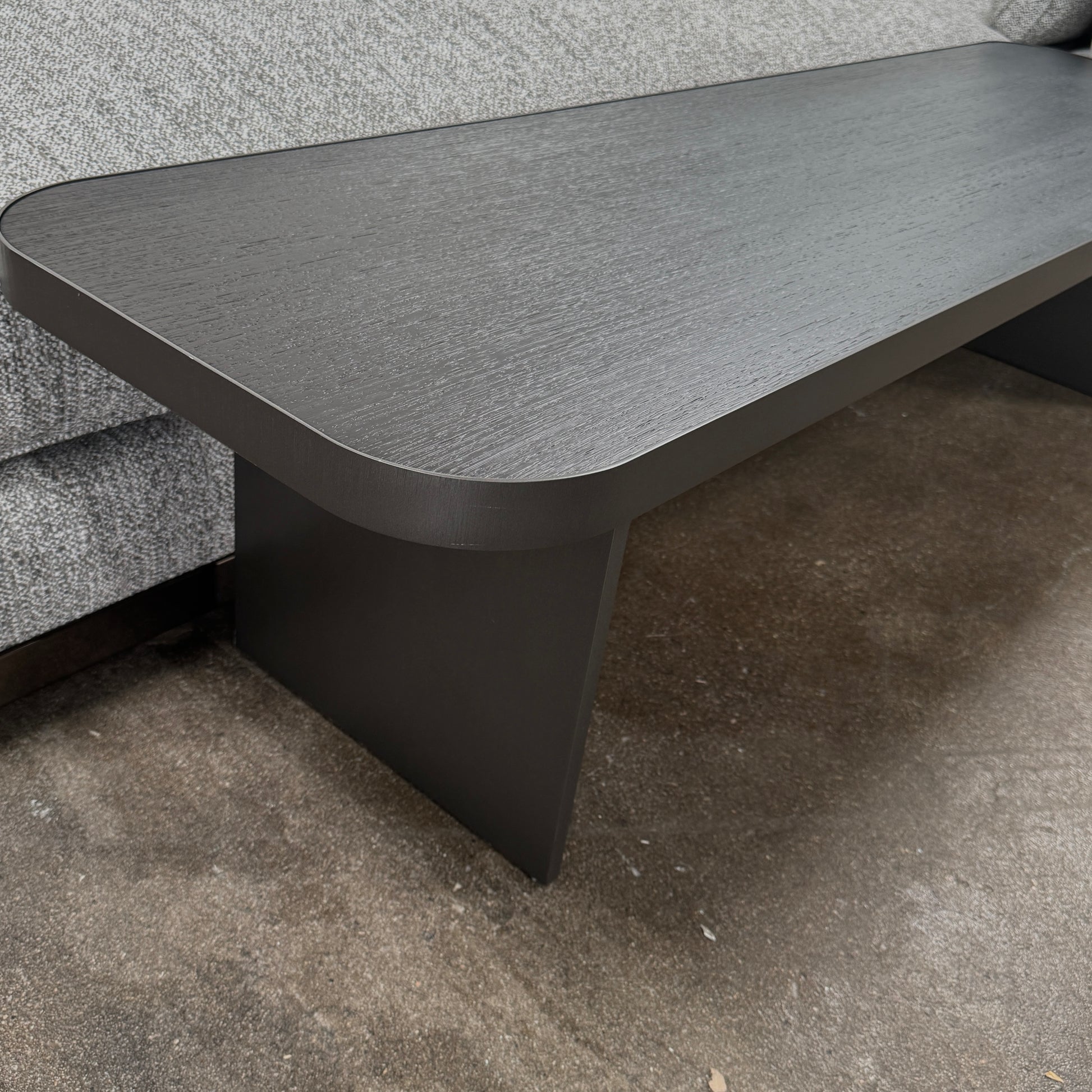 The Minotti West Sectional Sofa with Side Table and Clive Bench by Minotti features a large, L-shaped modern design with gray upholstery, multiple plush cushions, and an integrated side table—perfect for elevating luxury living rooms—all set against a plain white background.