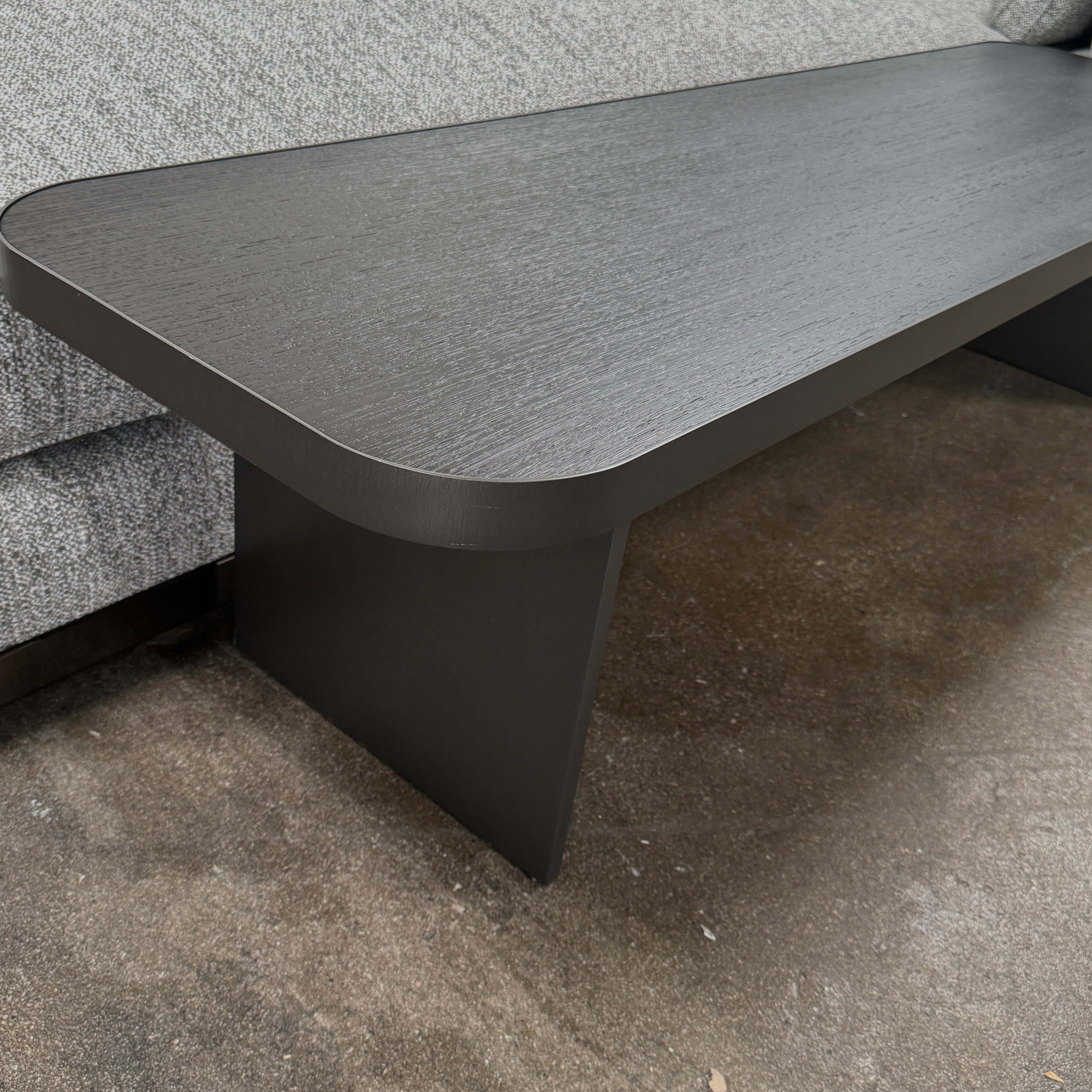 The Minotti West Sectional Sofa with Side Table and Clive Bench by Minotti features a large, L-shaped modern design with gray upholstery, multiple plush cushions, and an integrated side table—perfect for elevating luxury living rooms—all set against a plain white background.