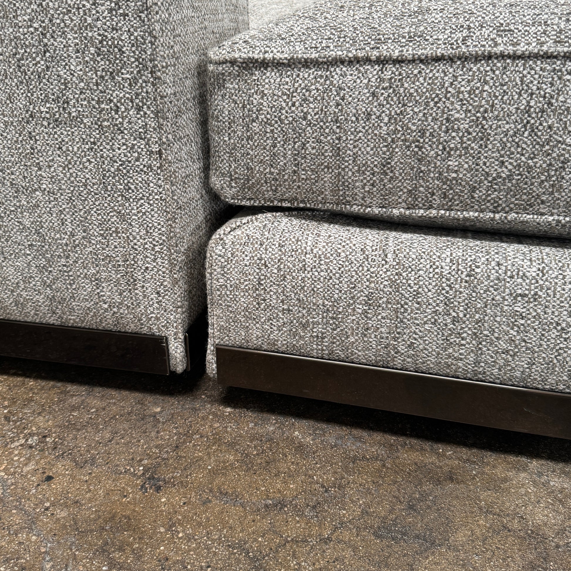 The Minotti West Sectional Sofa with Side Table and Clive Bench by Minotti features a large, L-shaped modern design with gray upholstery, multiple plush cushions, and an integrated side table—perfect for elevating luxury living rooms—all set against a plain white background.