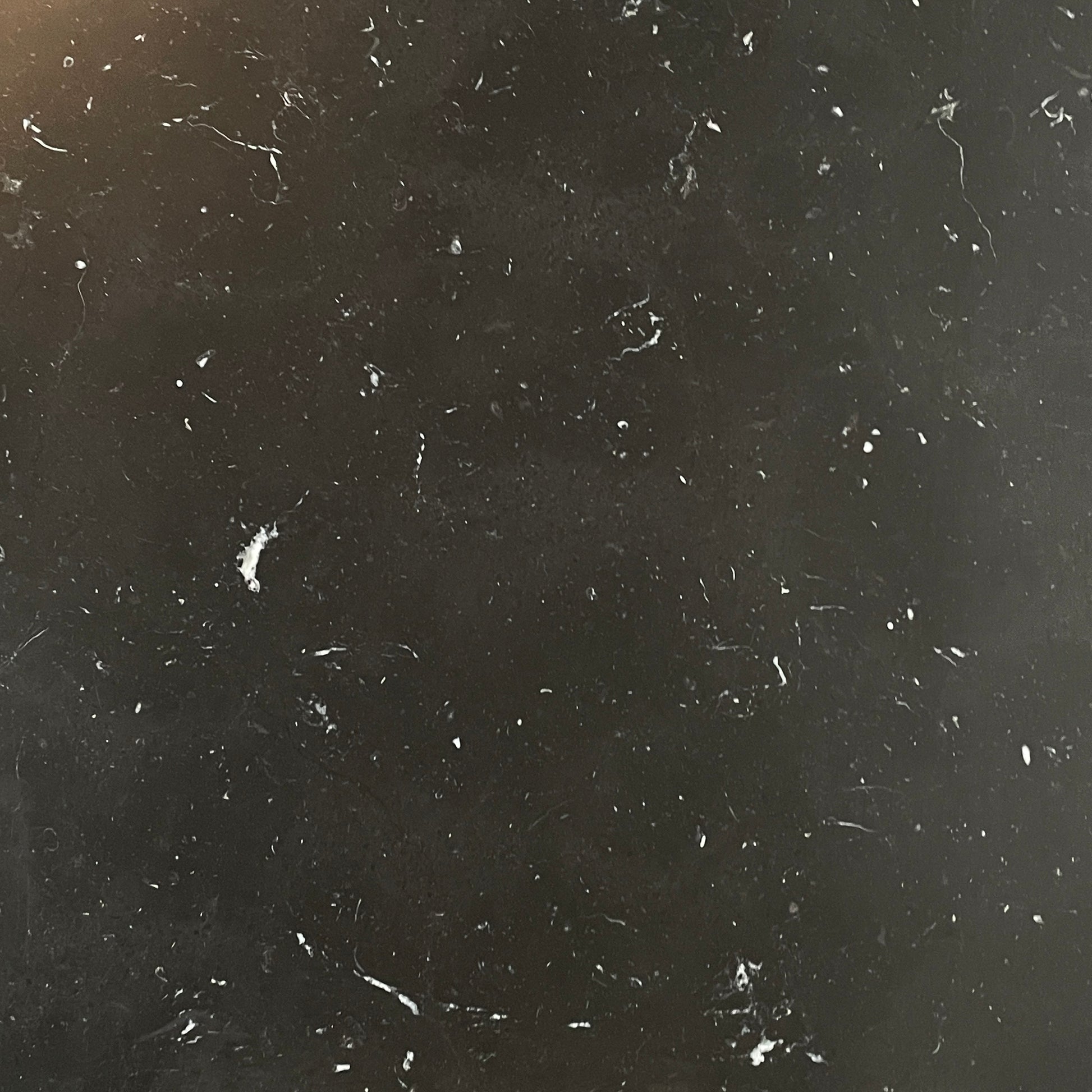 A minimalist rectangular black B&B Italia Diesis Coffee Table with metal legs, viewed directly from above, exudes timeless beauty against a plain white background.