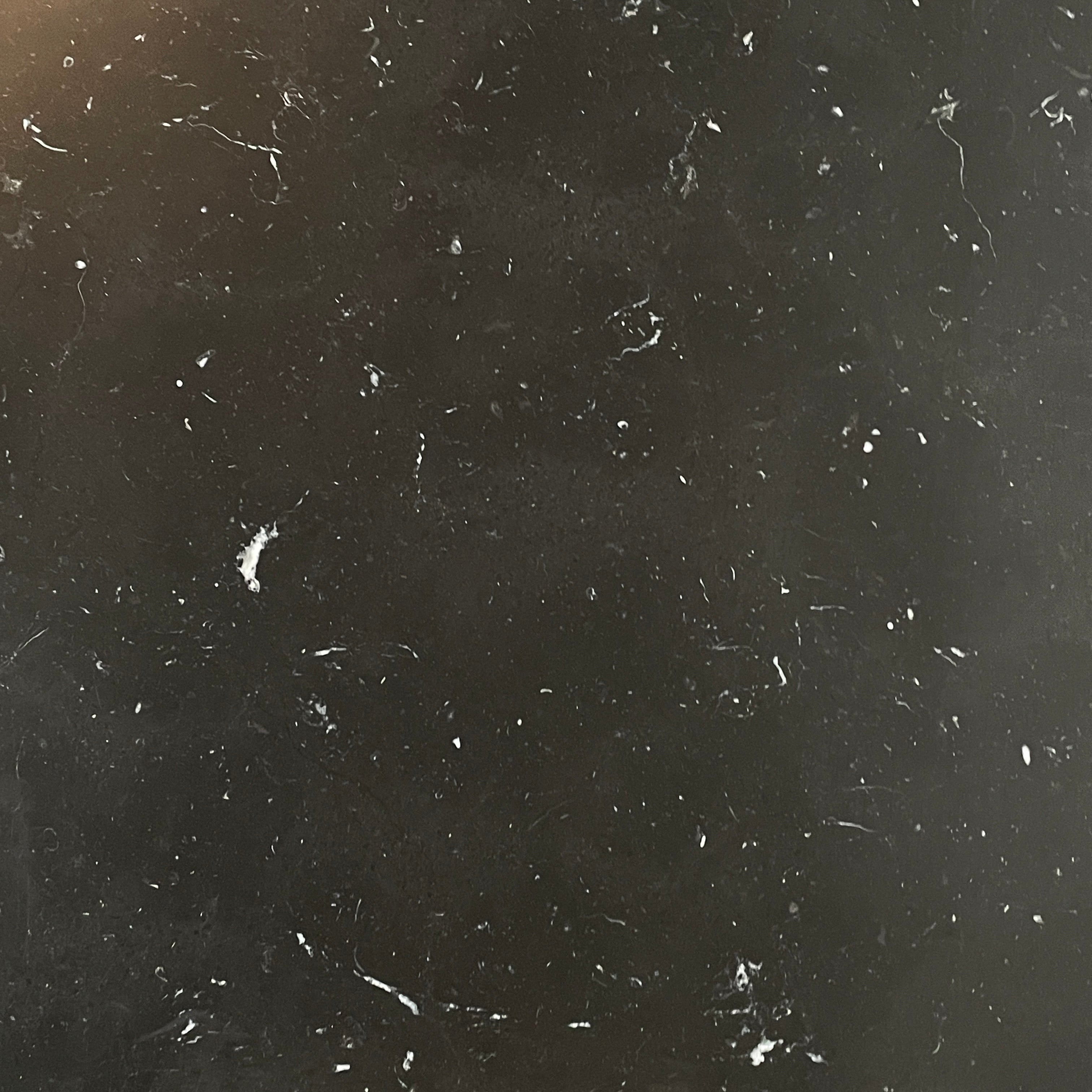 A minimalist rectangular black B&B Italia Diesis Coffee Table with metal legs, viewed directly from above, exudes timeless beauty against a plain white background.