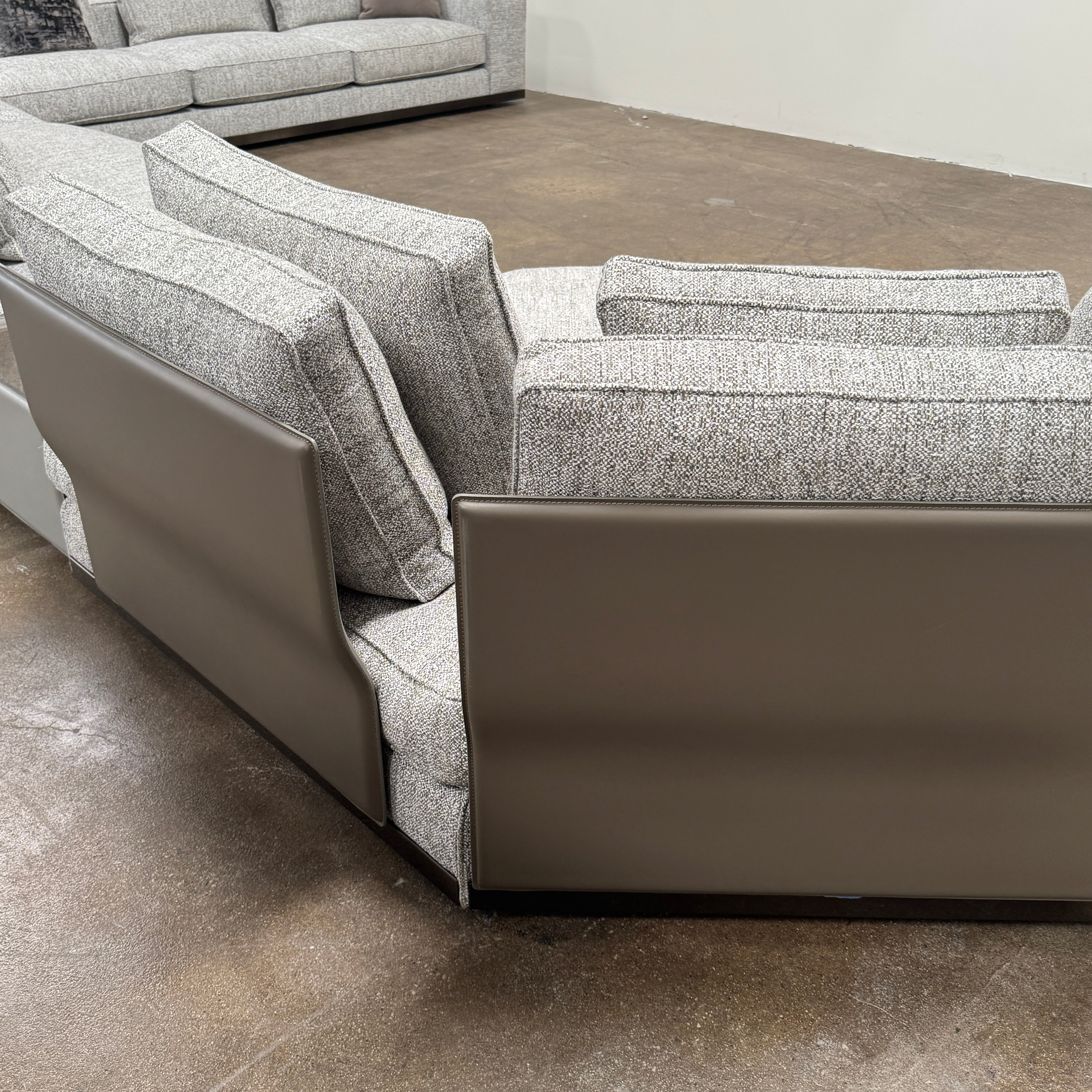 The Minotti West Sectional Sofa with Side Table and Clive Bench by Minotti features a large, L-shaped modern design with gray upholstery, multiple plush cushions, and an integrated side table—perfect for elevating luxury living rooms—all set against a plain white background.