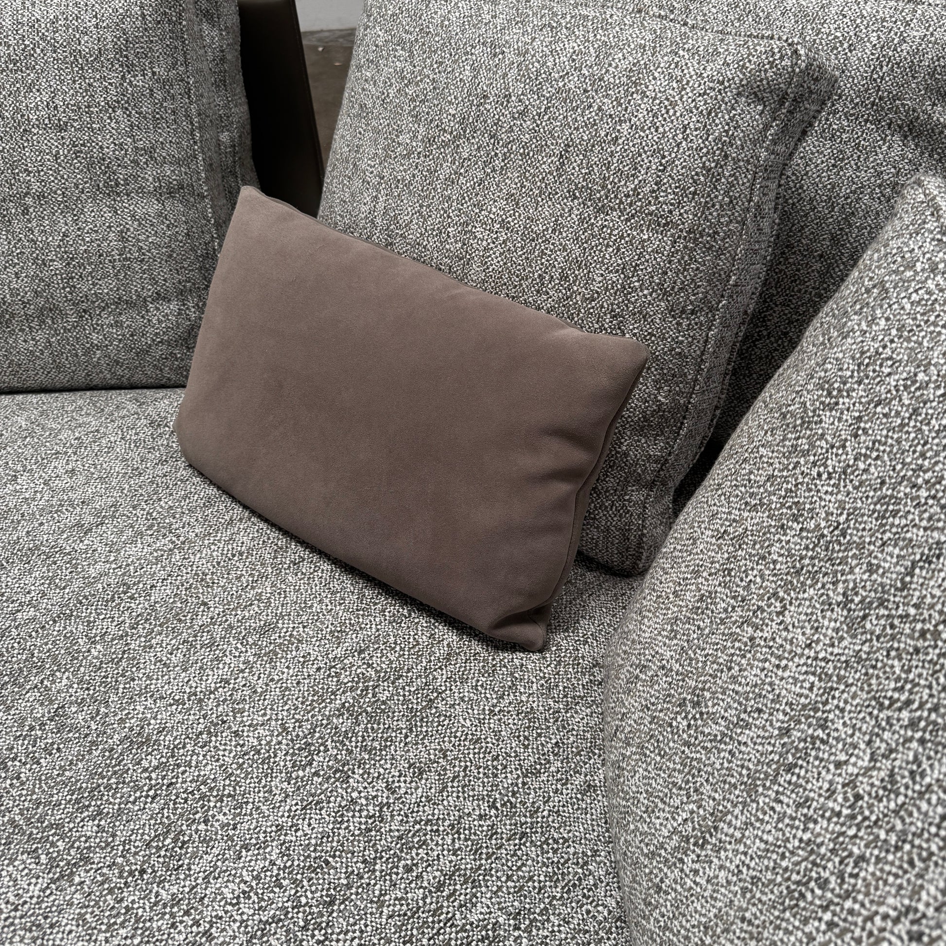 The Minotti West Sectional Sofa with Side Table and Clive Bench by Minotti features a large, L-shaped modern design with gray upholstery, multiple plush cushions, and an integrated side table—perfect for elevating luxury living rooms—all set against a plain white background.