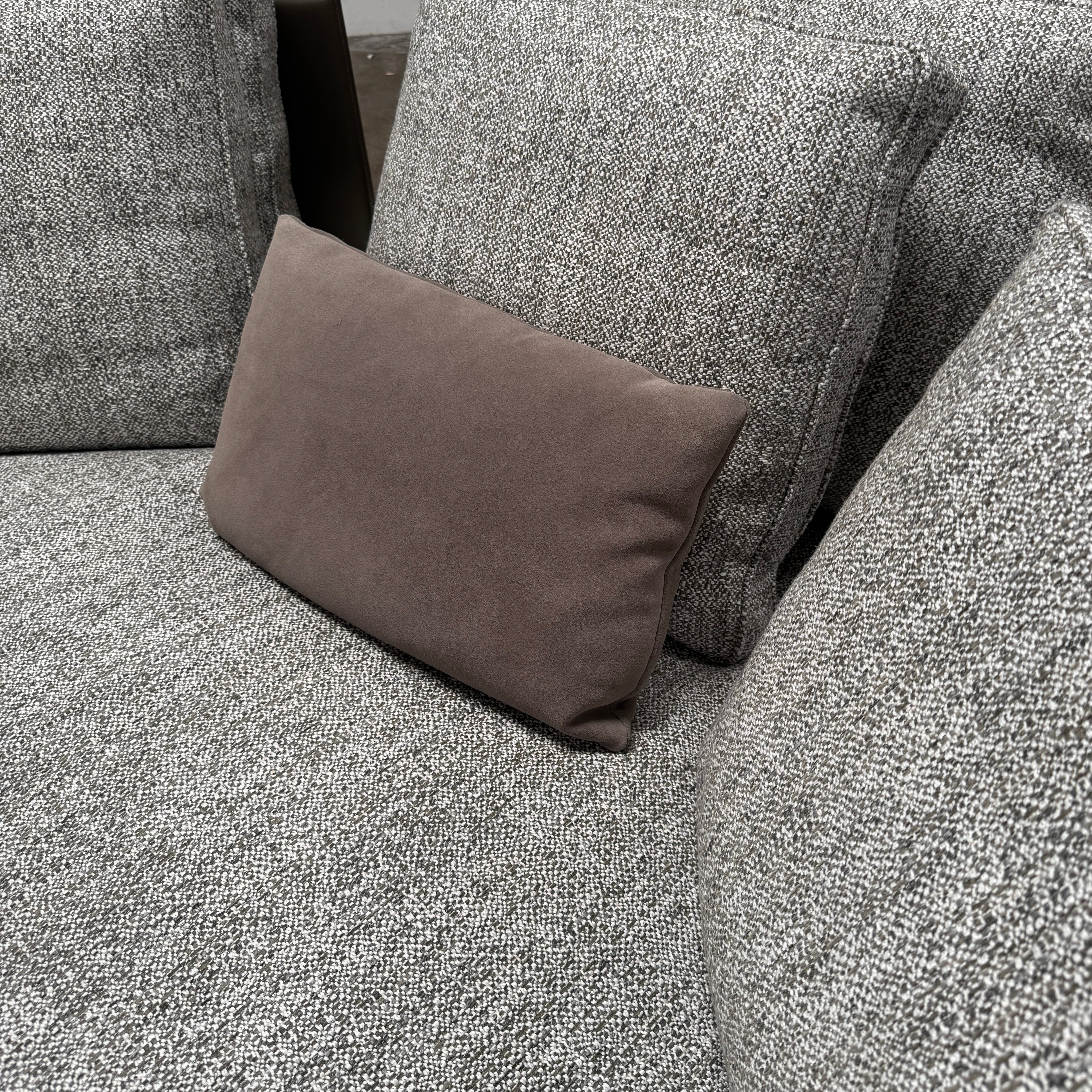 The Minotti West Sectional Sofa with Side Table and Clive Bench by Minotti features a large, L-shaped modern design with gray upholstery, multiple plush cushions, and an integrated side table—perfect for elevating luxury living rooms—all set against a plain white background.