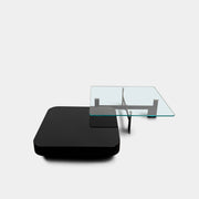 The Minotti Milton + Ellis Coffee Table Set by Minotti features a contemporary design with a black rectangular base and an attached elevated glass top supported by sleek metal brackets, presented against a plain white background.