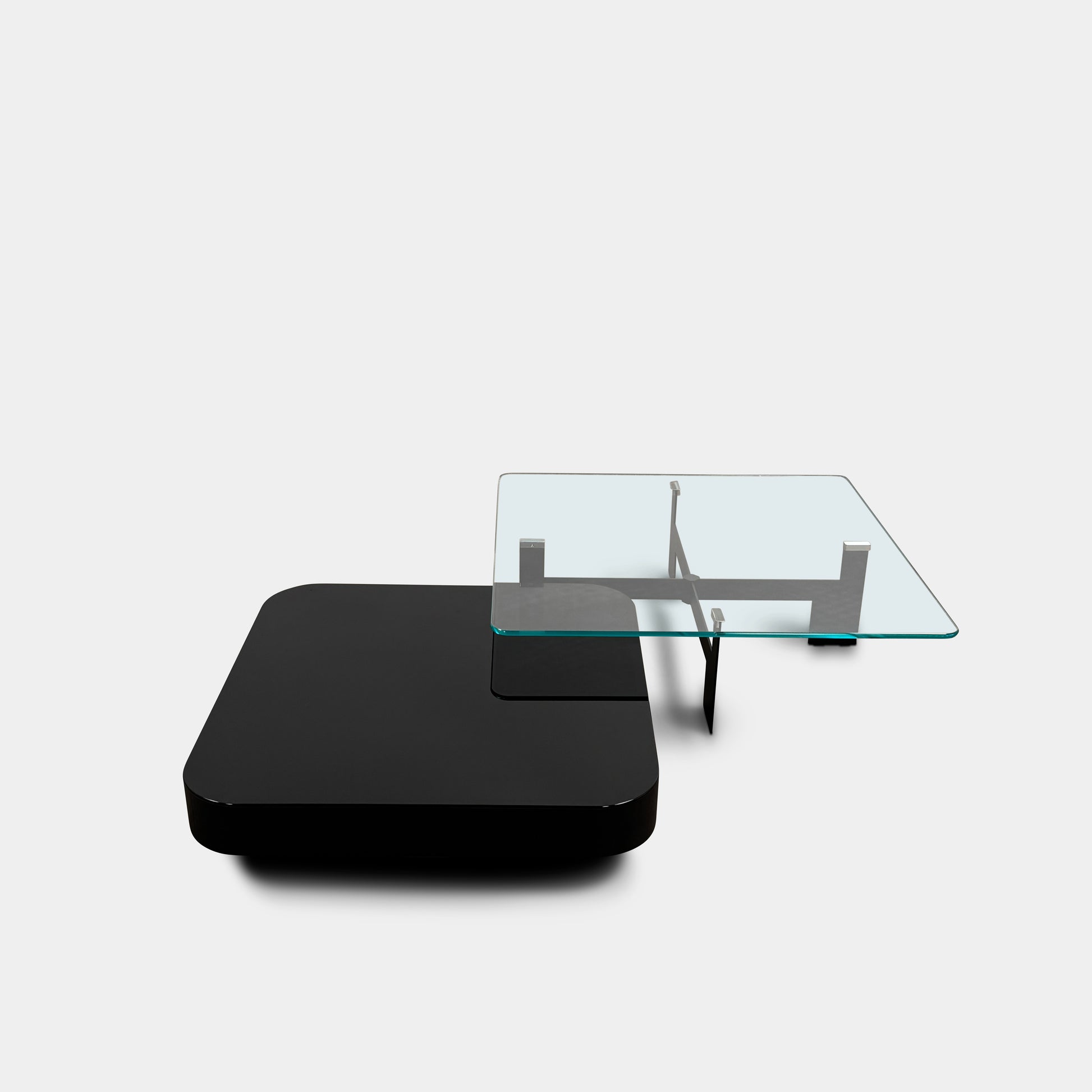 The Minotti Milton + Ellis Coffee Table Set by Minotti features a contemporary design with a black rectangular base and an attached elevated glass top supported by sleek metal brackets, presented against a plain white background.