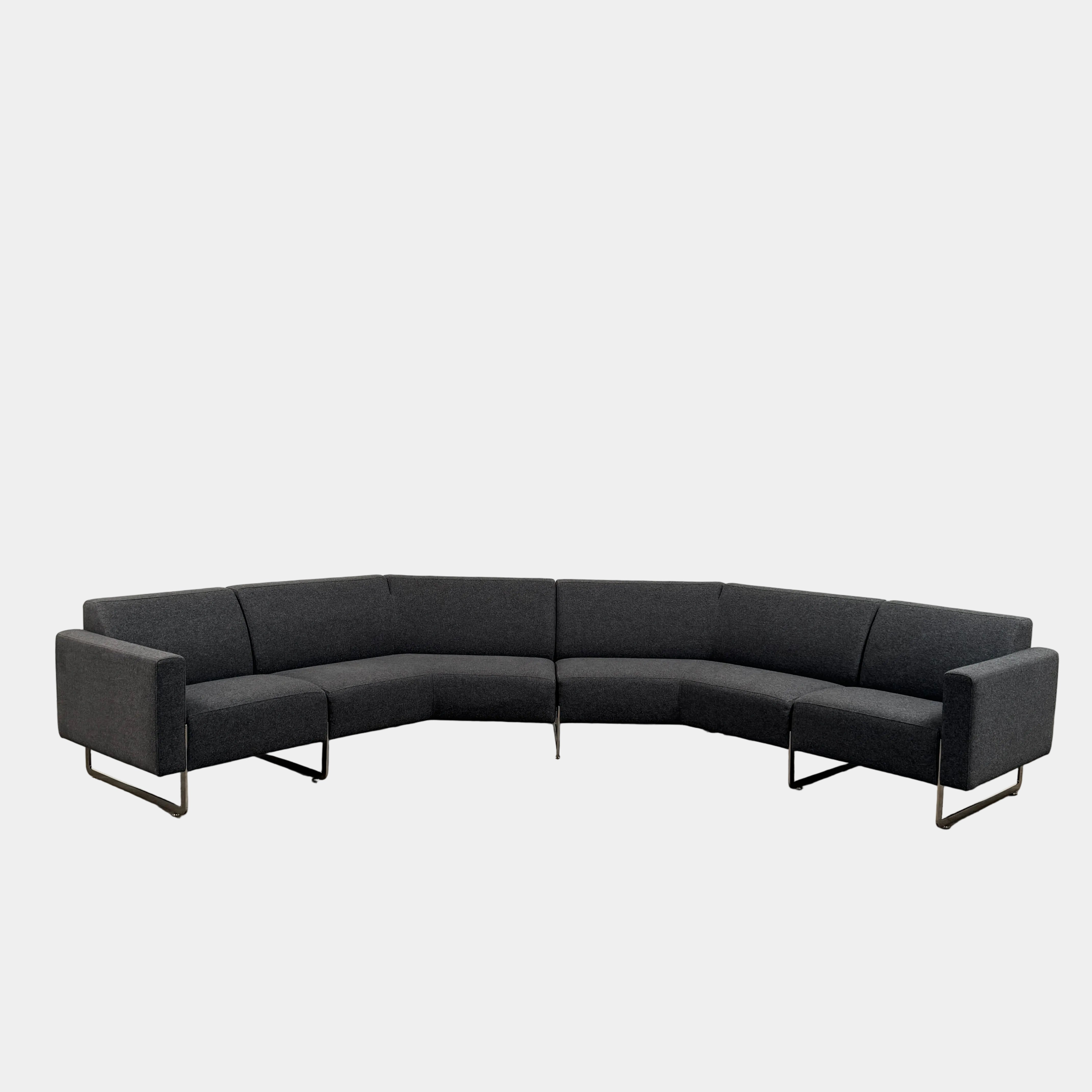 The Artifort More Mare Sectional by Artifort is a modern, dark gray sectional sofa featuring a minimalist metal frame and luxurious gray wool upholstery inspired by René Holten’s design, set against a plain white background.