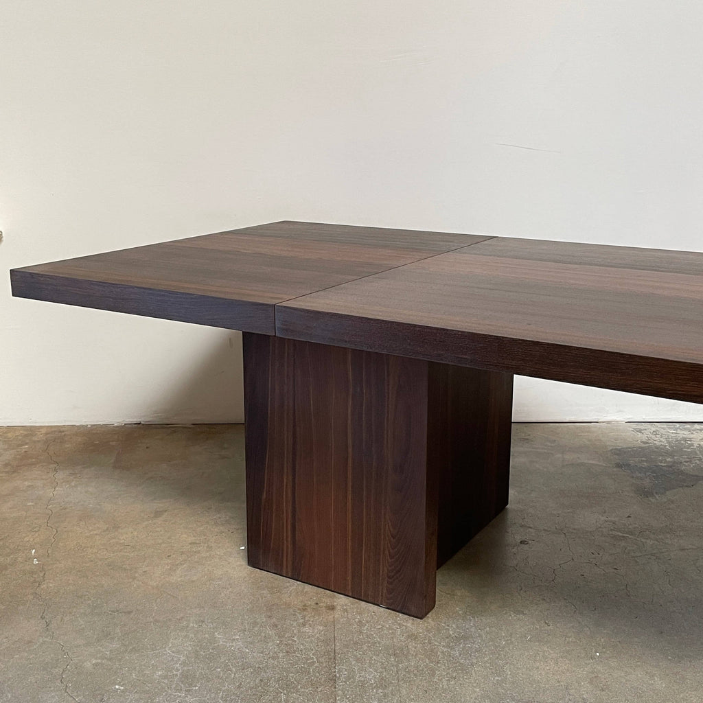 A modern E15 Isaac Folding Dining Table with a wooden base and lacquer finish.