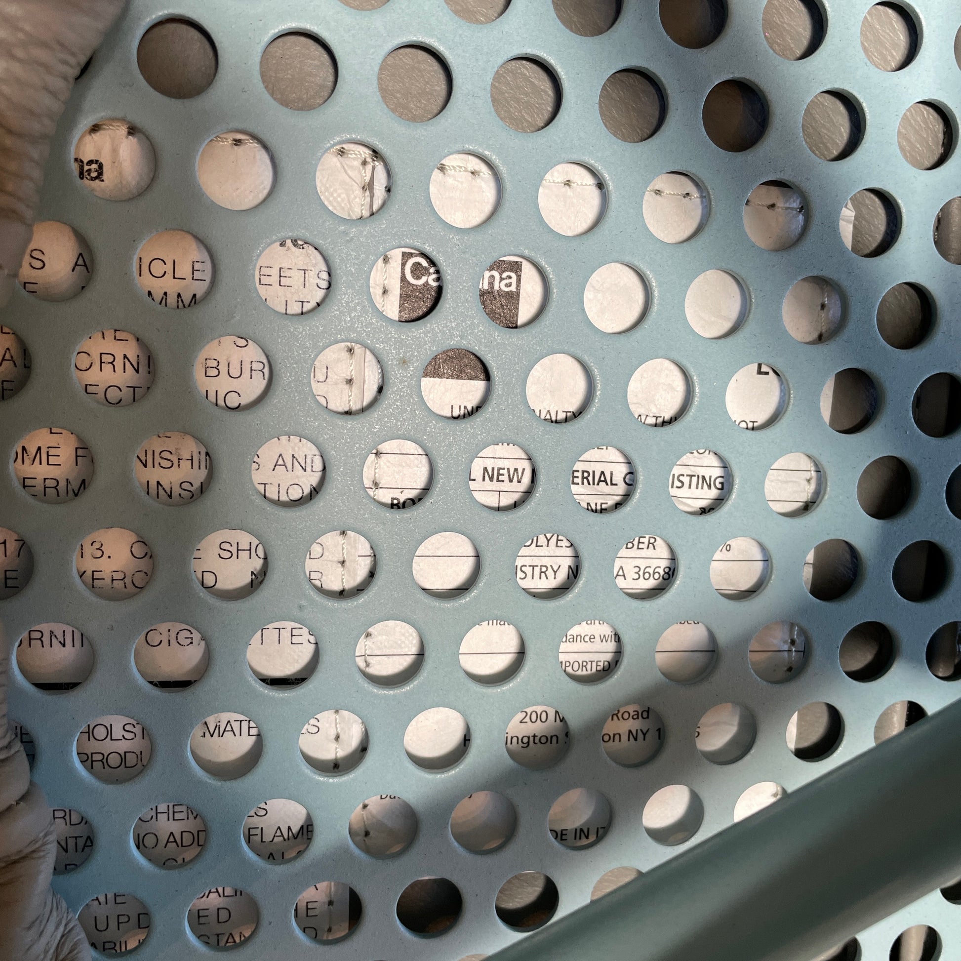 A gray leather Cassina LC7 Swivel Chair, featuring a circular seat, tubular backrest, and light blue metal legs, embodies modern design by Le Corbusier on a white background.