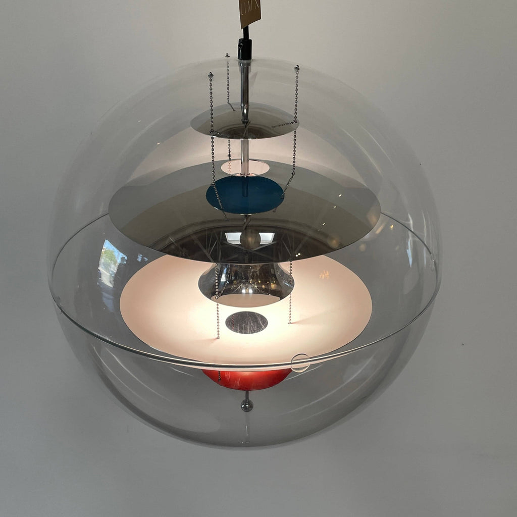 A modern Verner Panton VP Globe suspension light, featuring a clear glass globe that elegantly hangs from the ceiling.