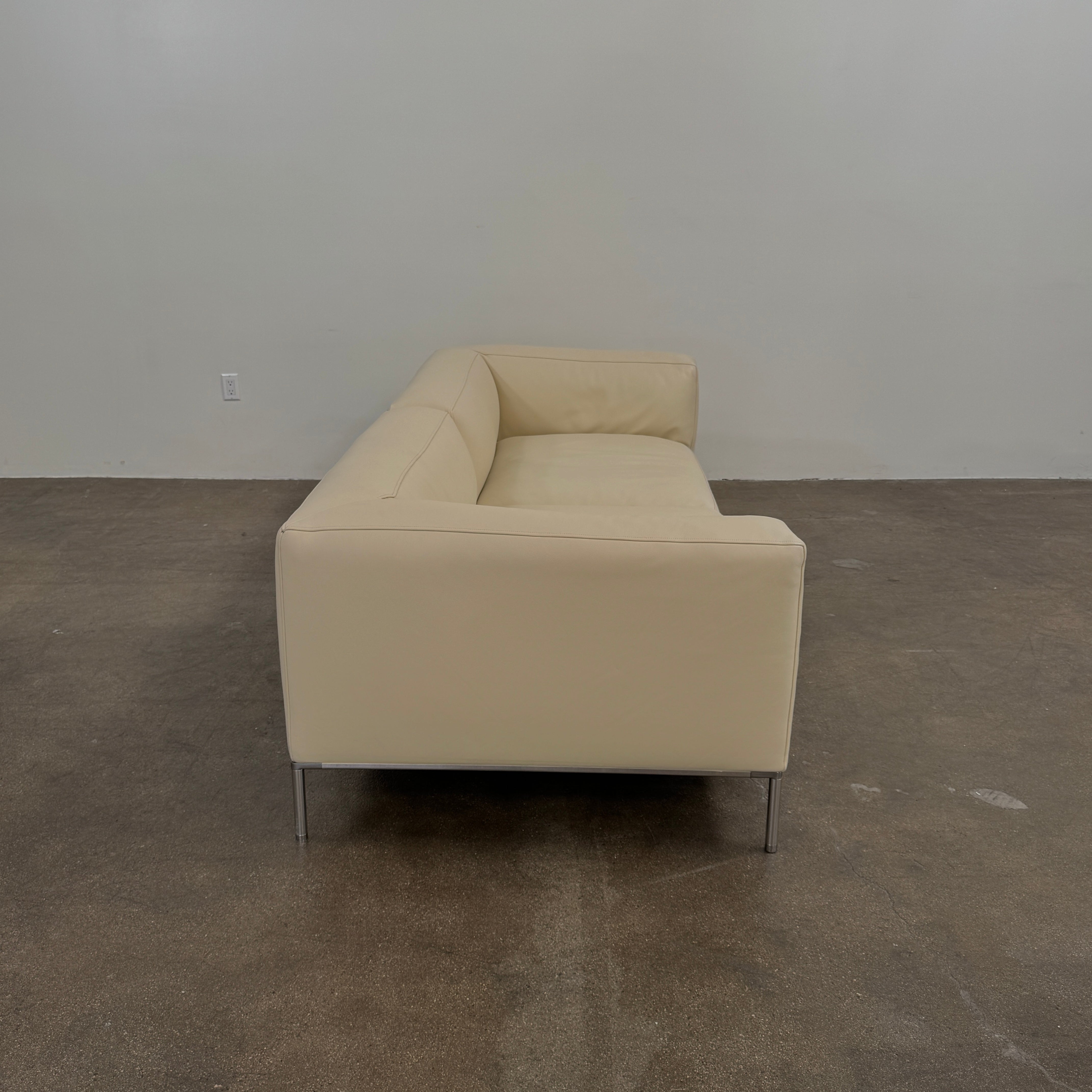 A beige B&B Italia Frank Sofa by B&B Italia, featuring metal legs and a minimalist modern design, is set against a plain white background.