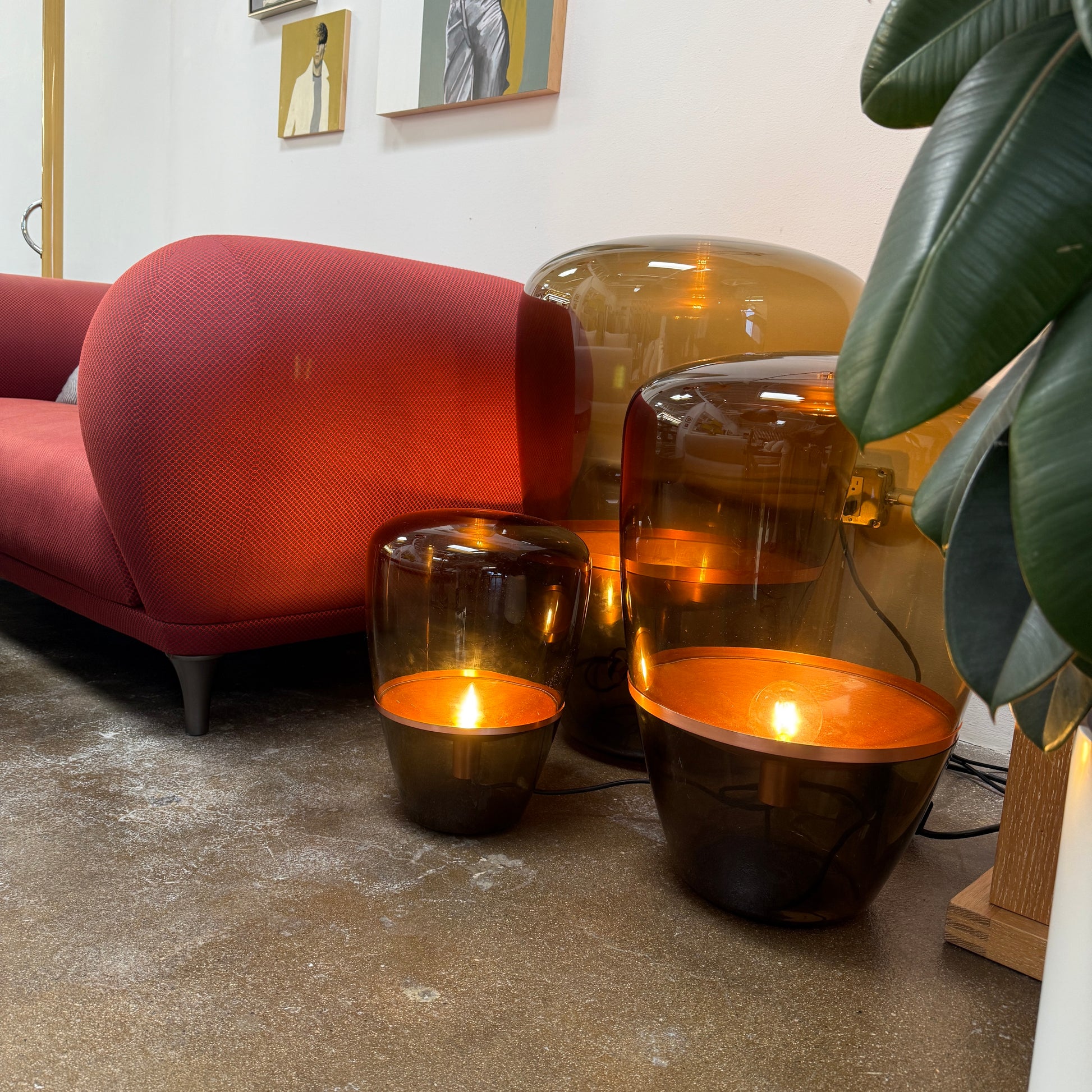Three Brokis Balloons LED Lamps with handblown glass and copper accents are arranged side by side against a white background, highlighting their elegant sculptural design.