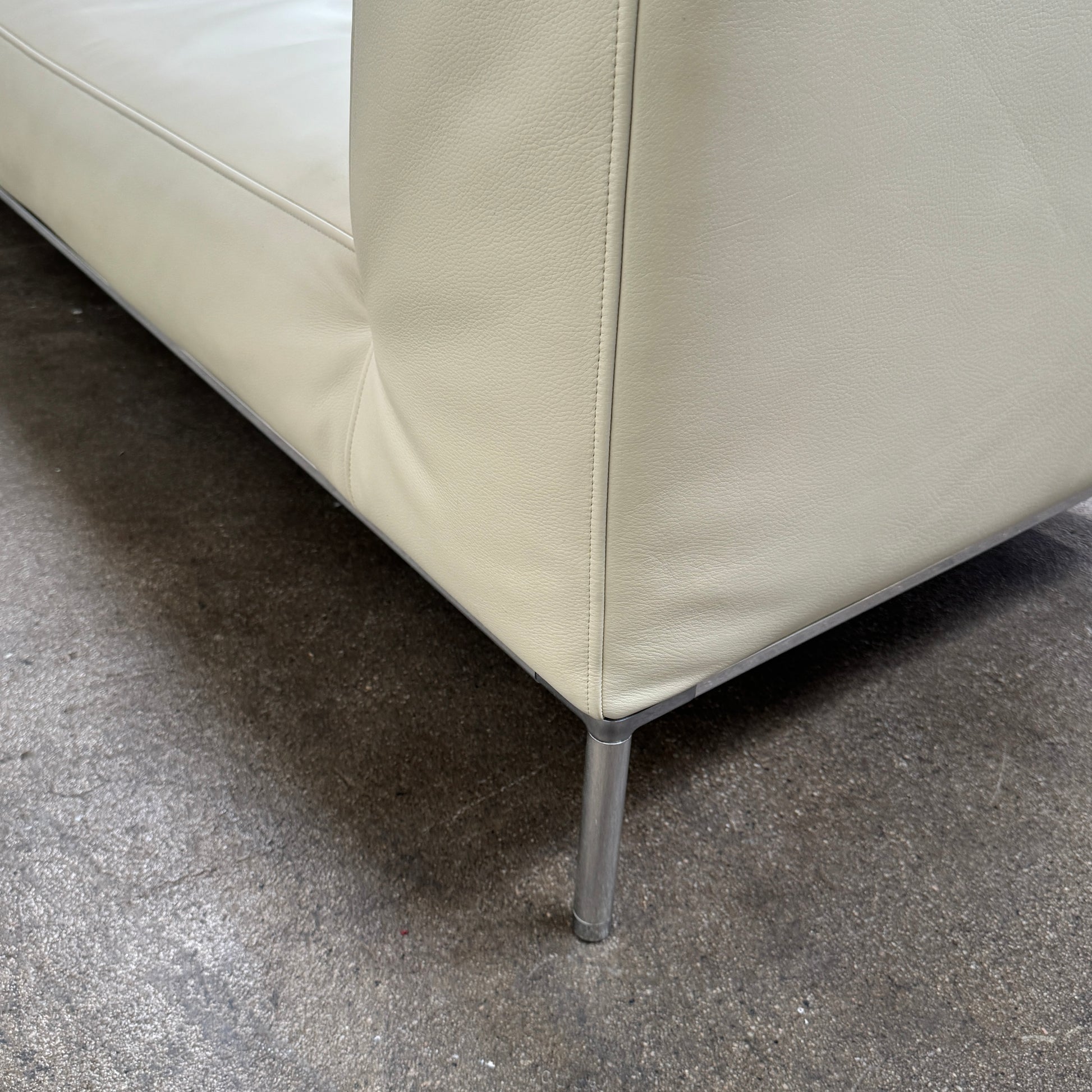 A beige B&B Italia Frank Sofa by B&B Italia, featuring metal legs and a minimalist modern design, is set against a plain white background.