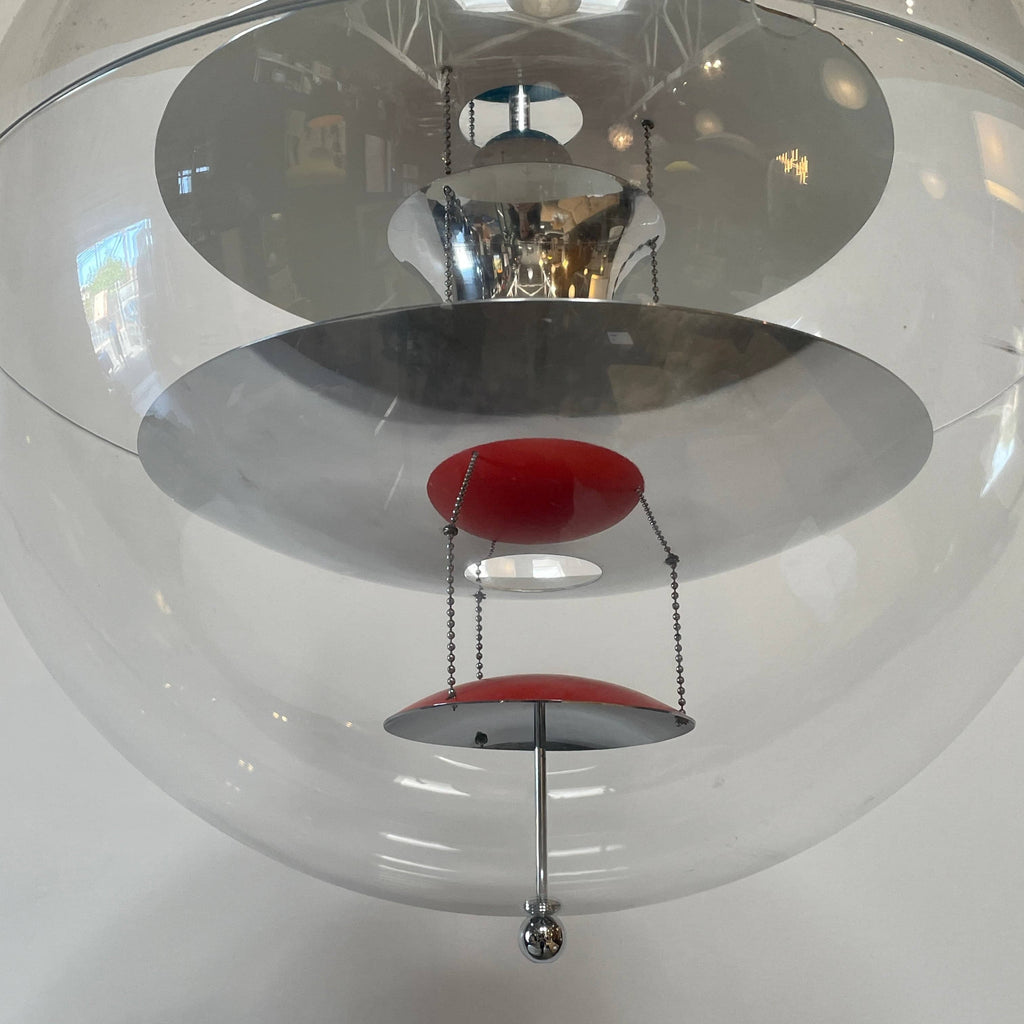 A modern Verner Panton VP Globe suspension light, featuring a clear glass globe that elegantly hangs from the ceiling.