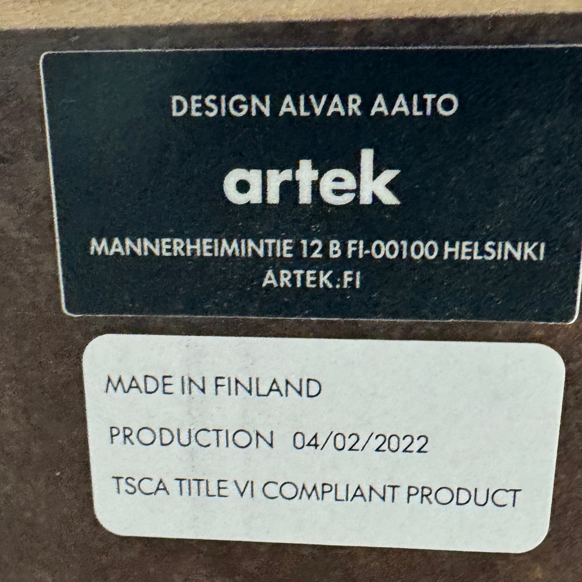 The Artek Aalto Tea Trolley 901 by Artek is a wooden bar cart inspired by the iconic Aalto Tea Trolley, showcasing two large white wheels, a handle, and two white shelves. Set against a plain white background, it stands as a testament to handcrafted Finnish design in the spirit of Alvar Aalto.