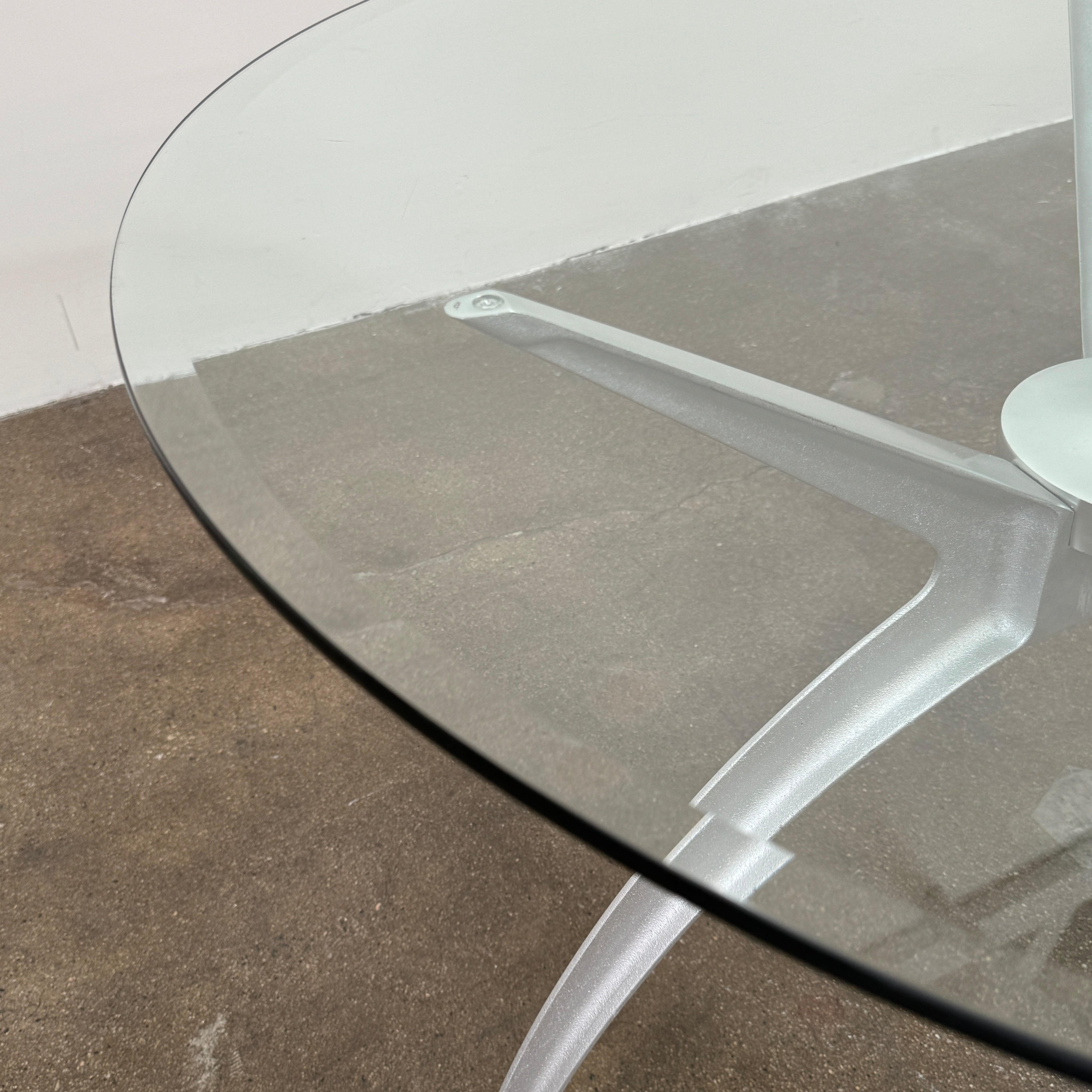Vintage BD Barcelona Arachnid Table by BD Barcelona, featuring a round glass top and three silver metallic legs, showcased on a plain white background—an eye-catching fusion of modern aesthetics and vintage elegance inspired by Pete Sans.