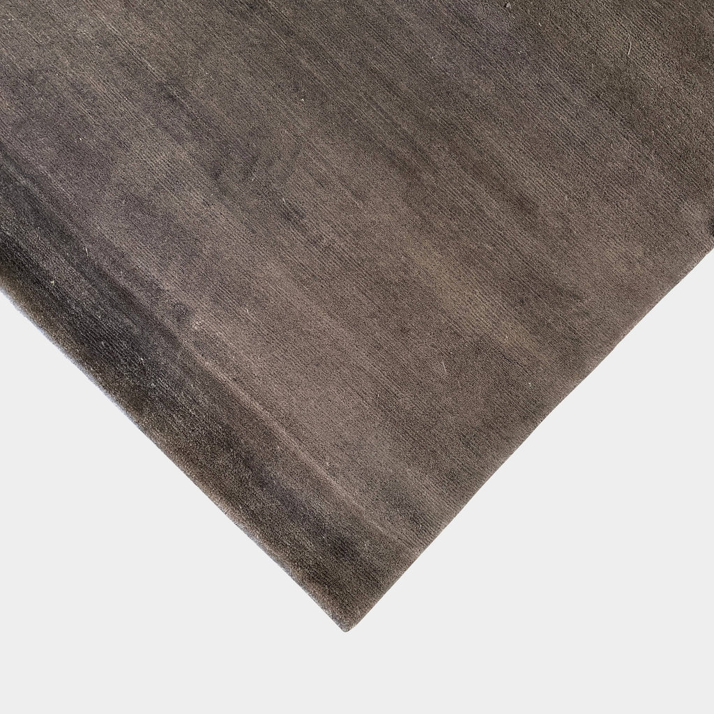 An image of a grey wooden floor with a Delinear Bamboo Charcoal 8' X 10' Rug.