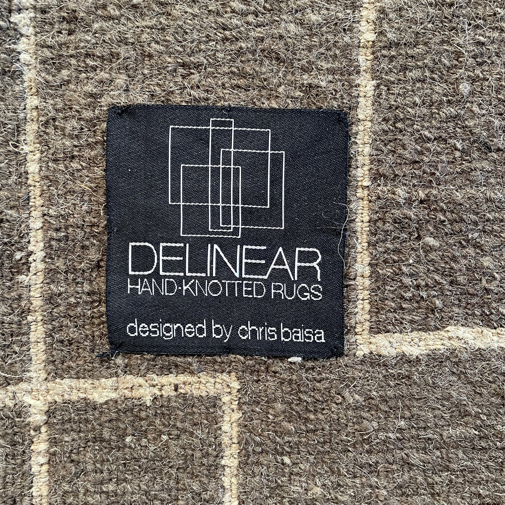 A brown and white Delinear Presence 8x10 Wool Rug with lines on it adds presence to any space.