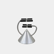 A silver metal cone base supports two curved arms with four black cylindrical grips, arranged symmetrically against a plain light background—an aesthetic reminiscent of the playful geometry seen in the Memphis movement, embodied by the Vintage Postmodern “Hotel Zeus” TV Stand for Zeus Milano by Zeus.