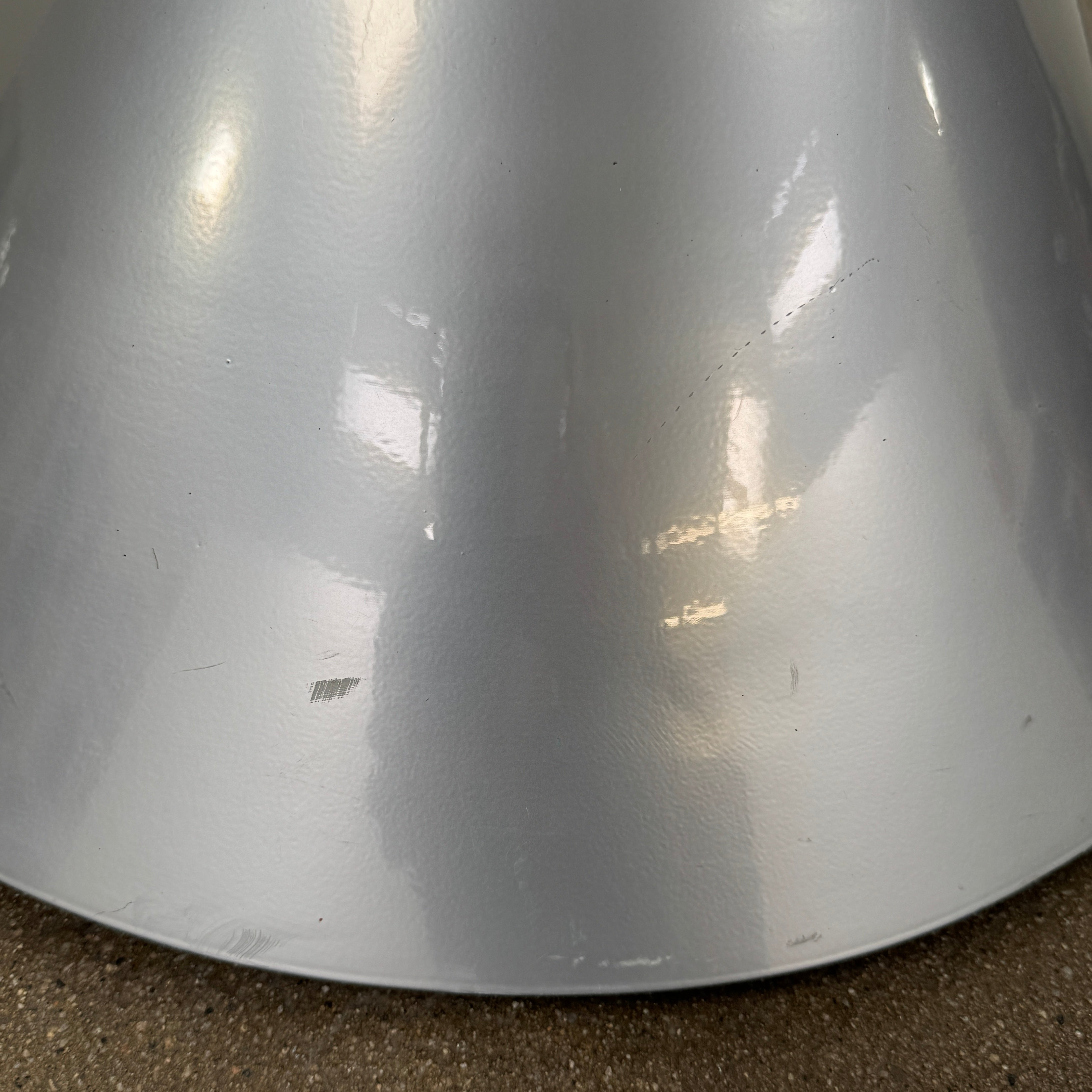 A silver metal cone base supports two curved arms with four black cylindrical grips, arranged symmetrically against a plain light background—an aesthetic reminiscent of the playful geometry seen in the Memphis movement, embodied by the Vintage Postmodern “Hotel Zeus” TV Stand for Zeus Milano by Zeus.