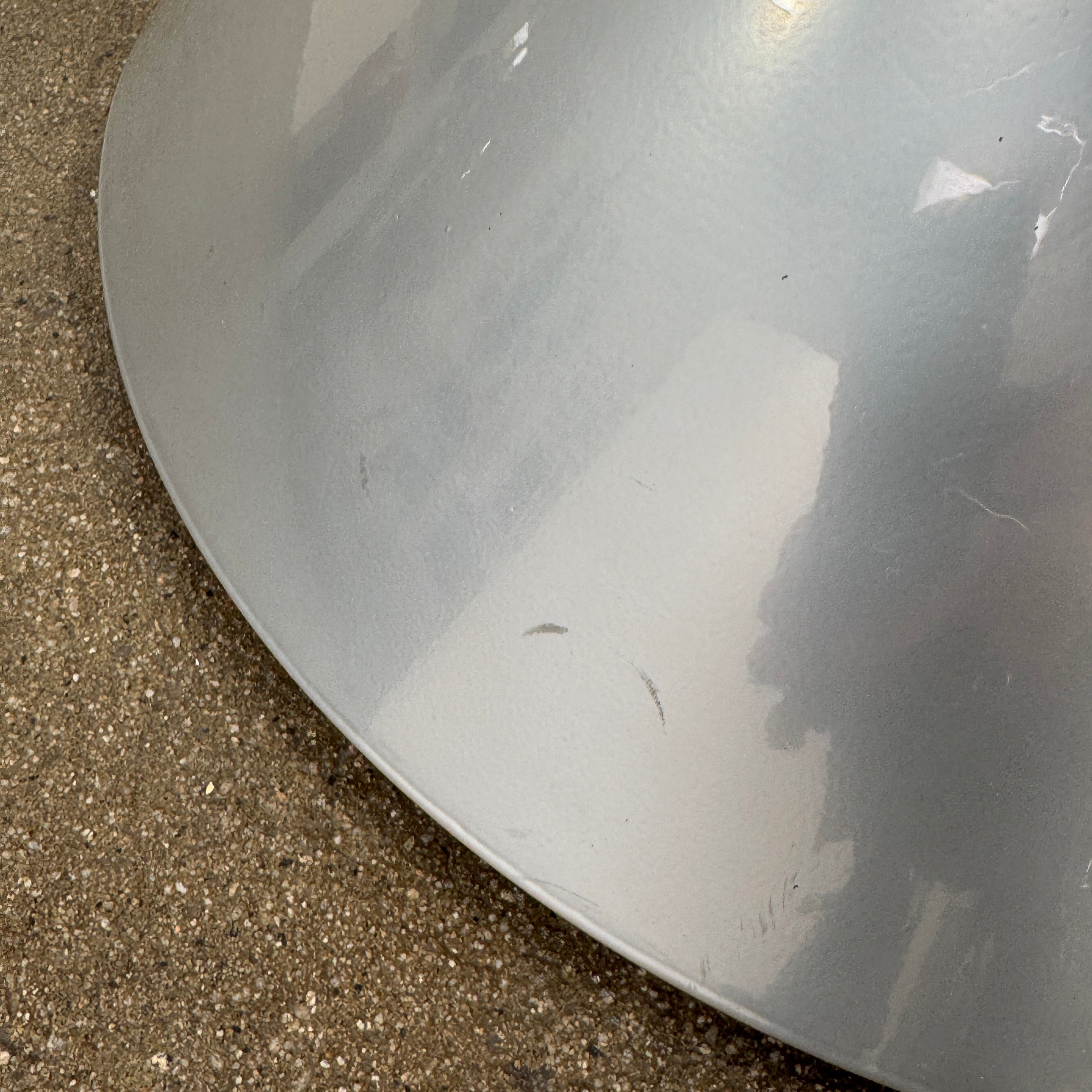 A silver metal cone base supports two curved arms with four black cylindrical grips, arranged symmetrically against a plain light background—an aesthetic reminiscent of the playful geometry seen in the Memphis movement, embodied by the Vintage Postmodern “Hotel Zeus” TV Stand for Zeus Milano by Zeus.
