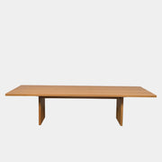A Dk3 Gather table, crafted from solid oak with a flat rectangular top and two wide, flat legs at each end, is set against a plain white background.