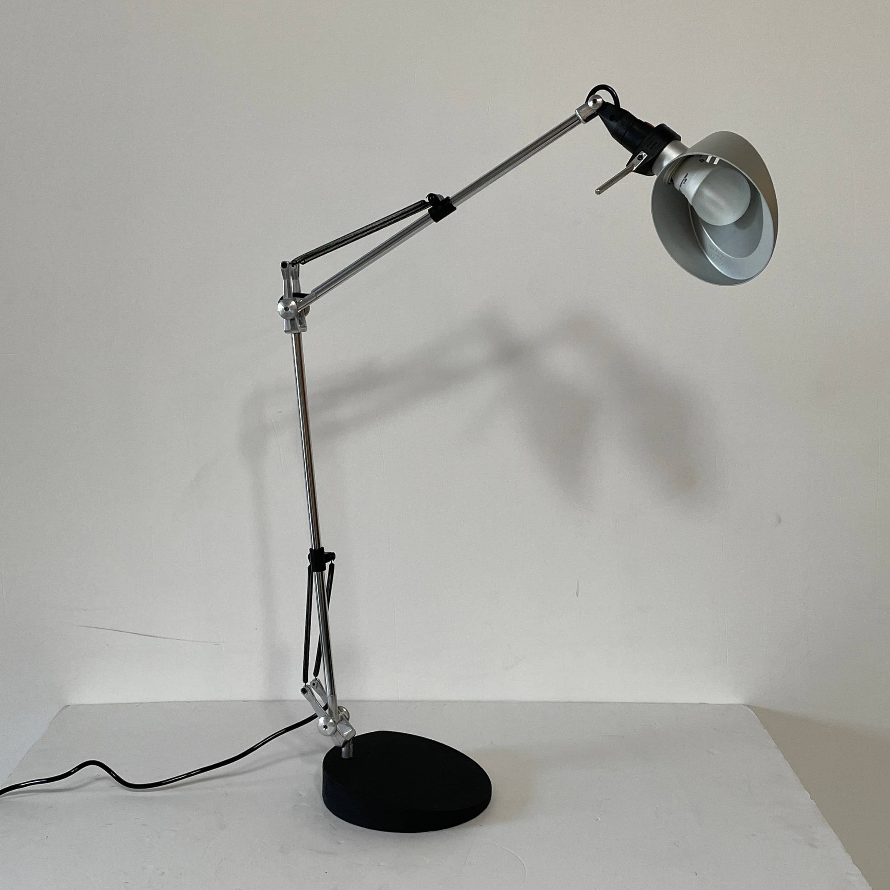 A Fontana Arte Chrono Task Lamp with a black shade and white background.