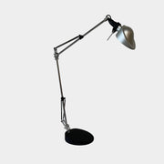A Fontana Arte Chrono Task Lamp with a black shade and white background.