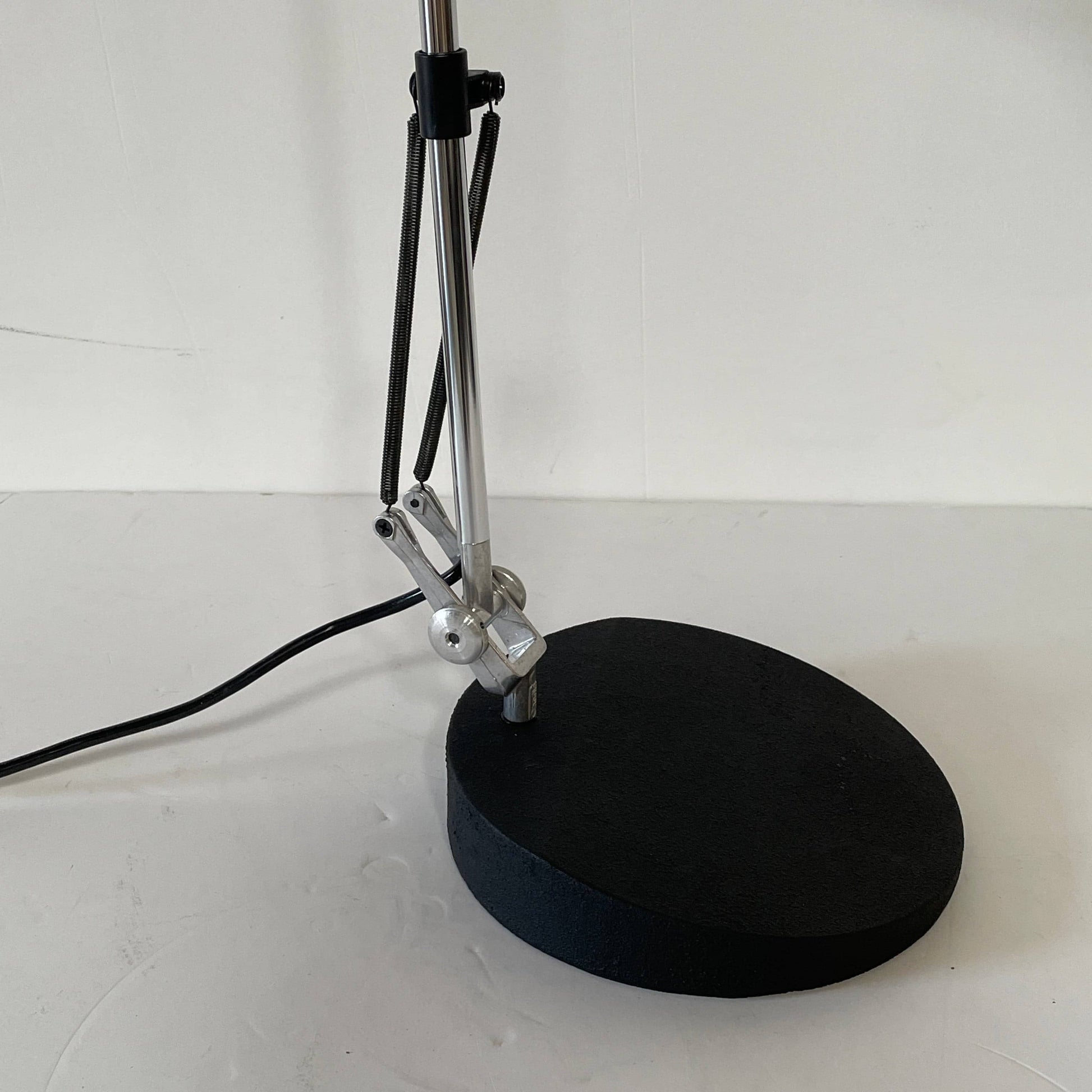 A Fontana Arte Chrono Task Lamp with a black shade and white background.