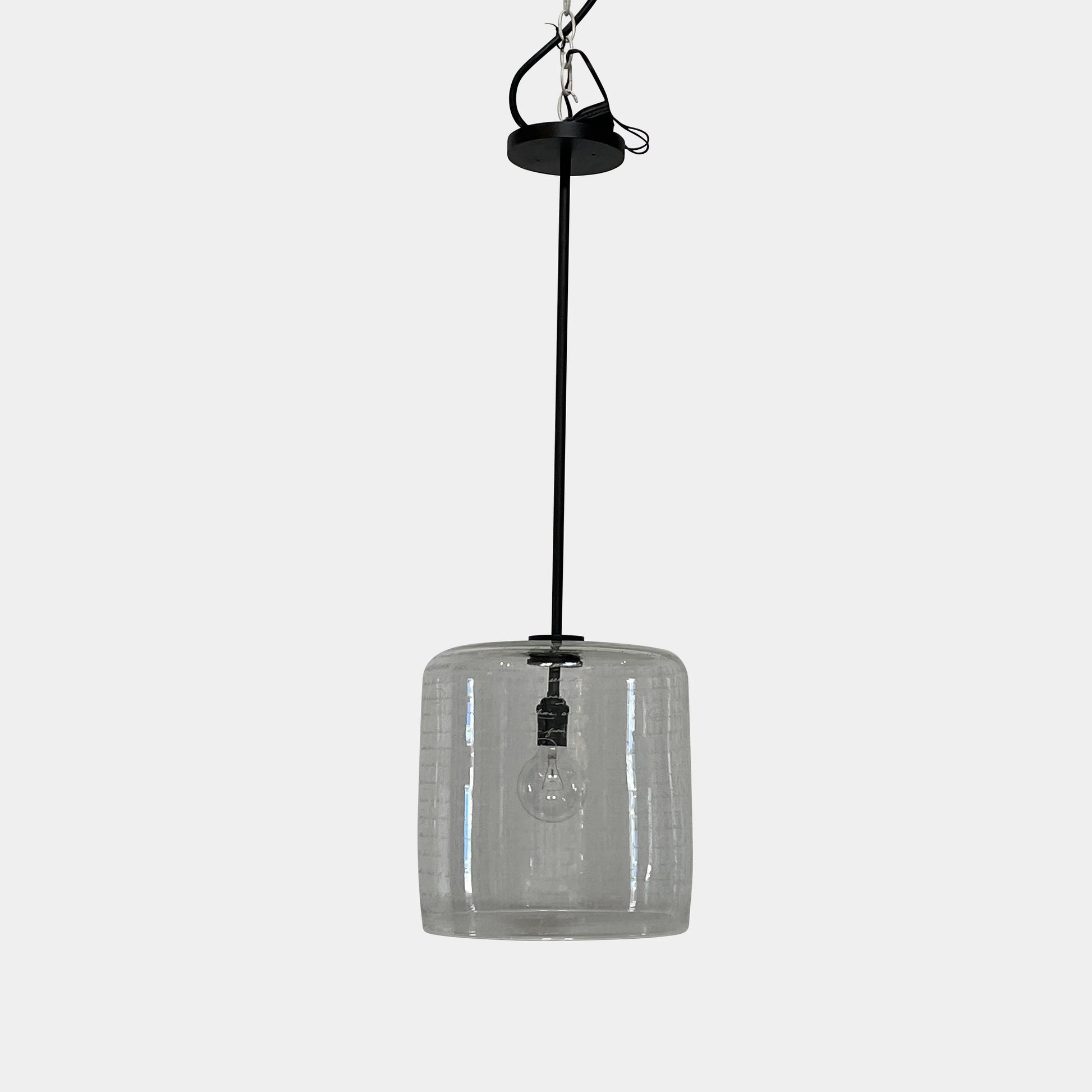 A unique functional art piece, this Alison Berger Word Pendant by Alison Berger showcases visible wires and mounting hardware against a white textured ceiling, reminiscent of Alison Berger's Word Pendant designs.