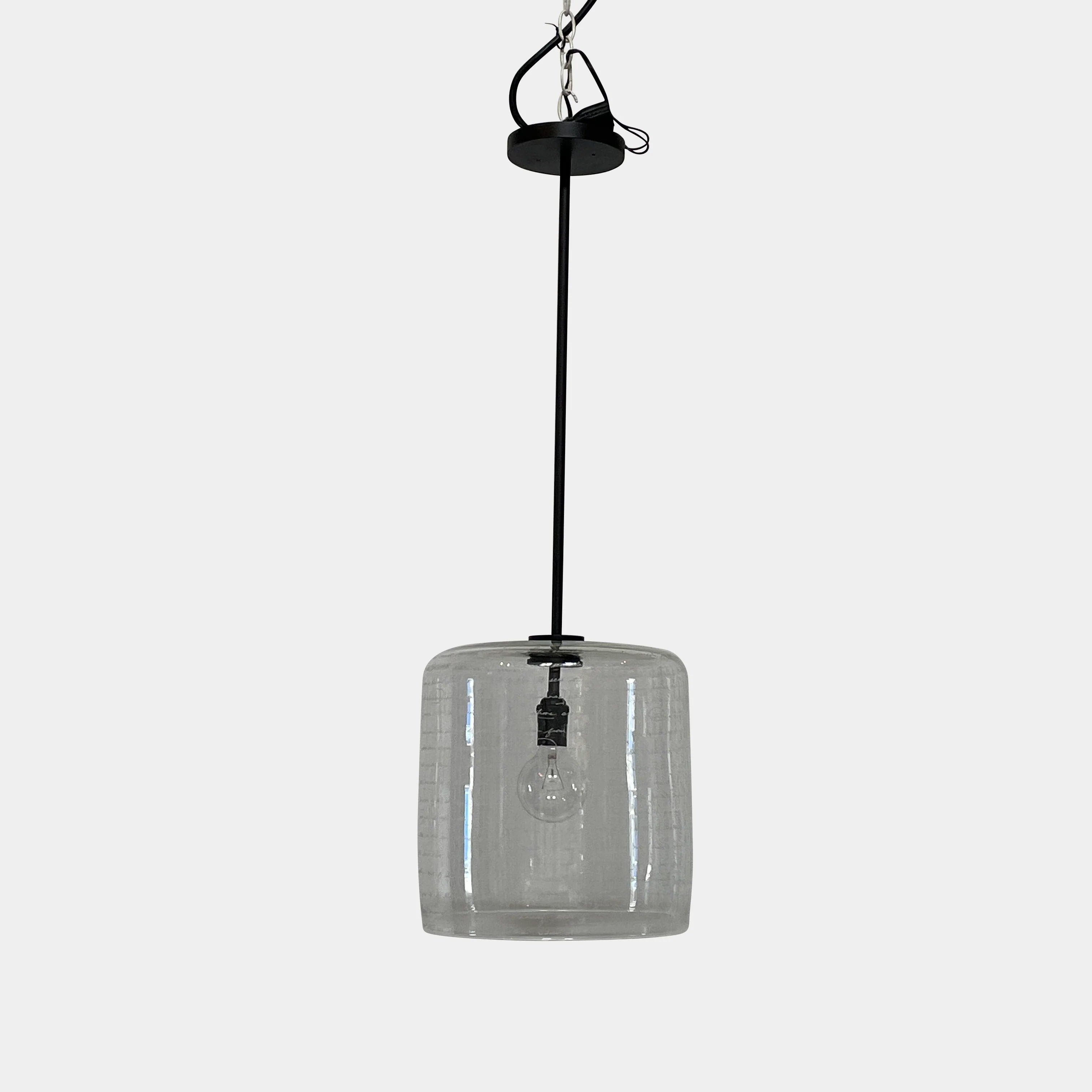 A unique functional art piece, this Alison Berger Word Pendant by Alison Berger showcases visible wires and mounting hardware against a white textured ceiling, reminiscent of Alison Berger's Word Pendant designs.