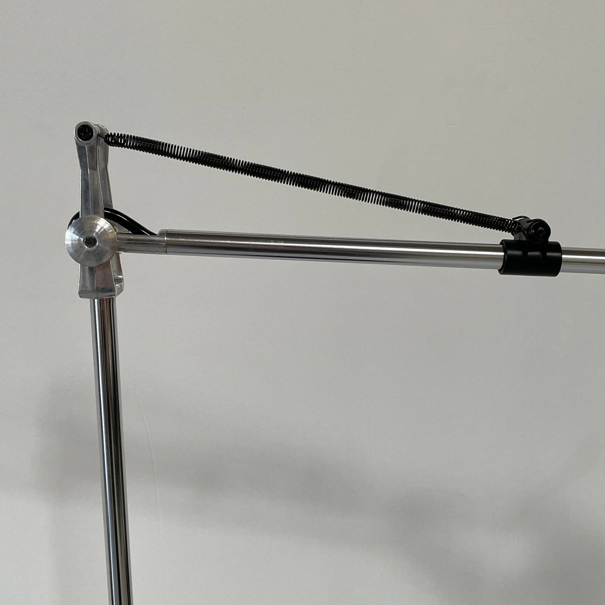 A Fontana Arte Chrono Task Lamp with a black shade and white background.