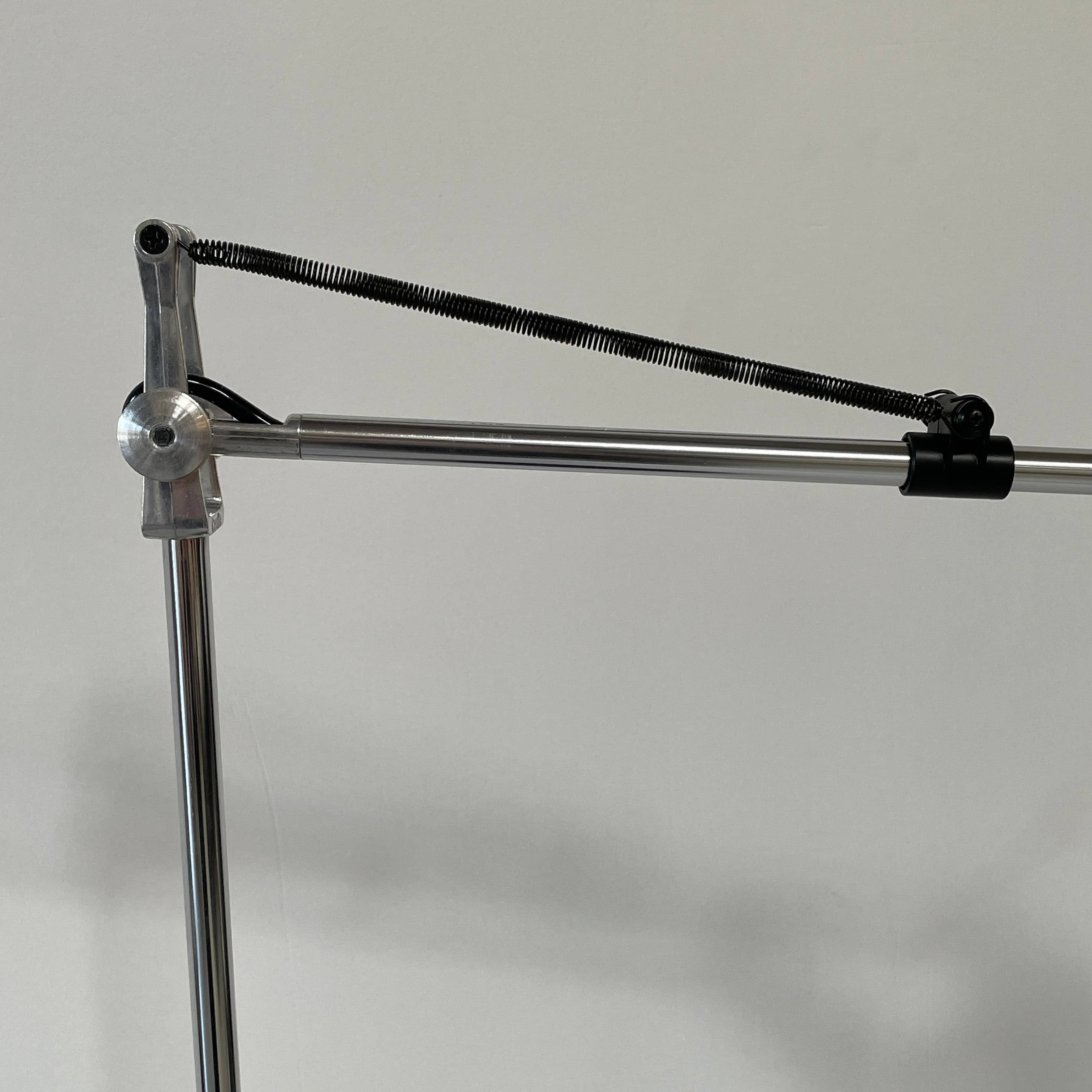 A Fontana Arte Chrono Task Lamp with a black shade and white background.