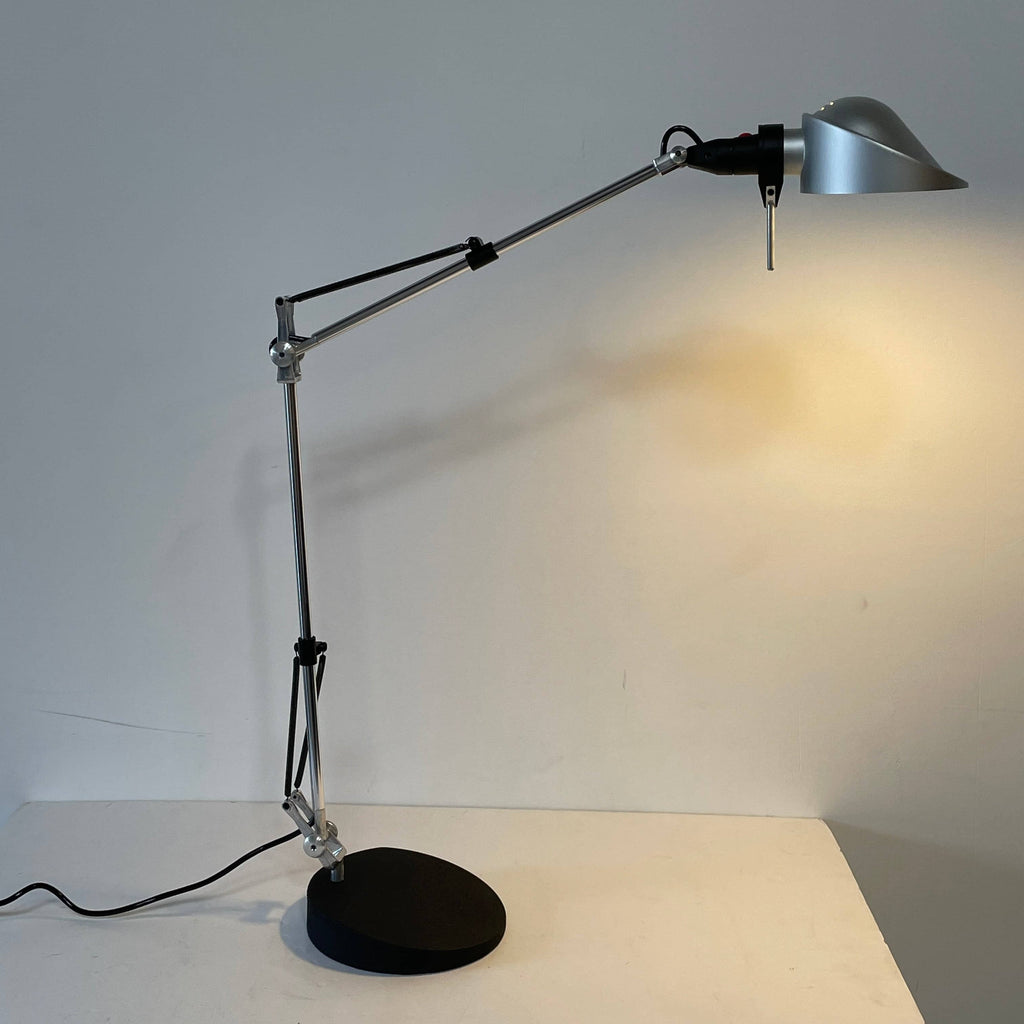 A Fontana Arte Chrono Task Lamp with a black shade and white background.