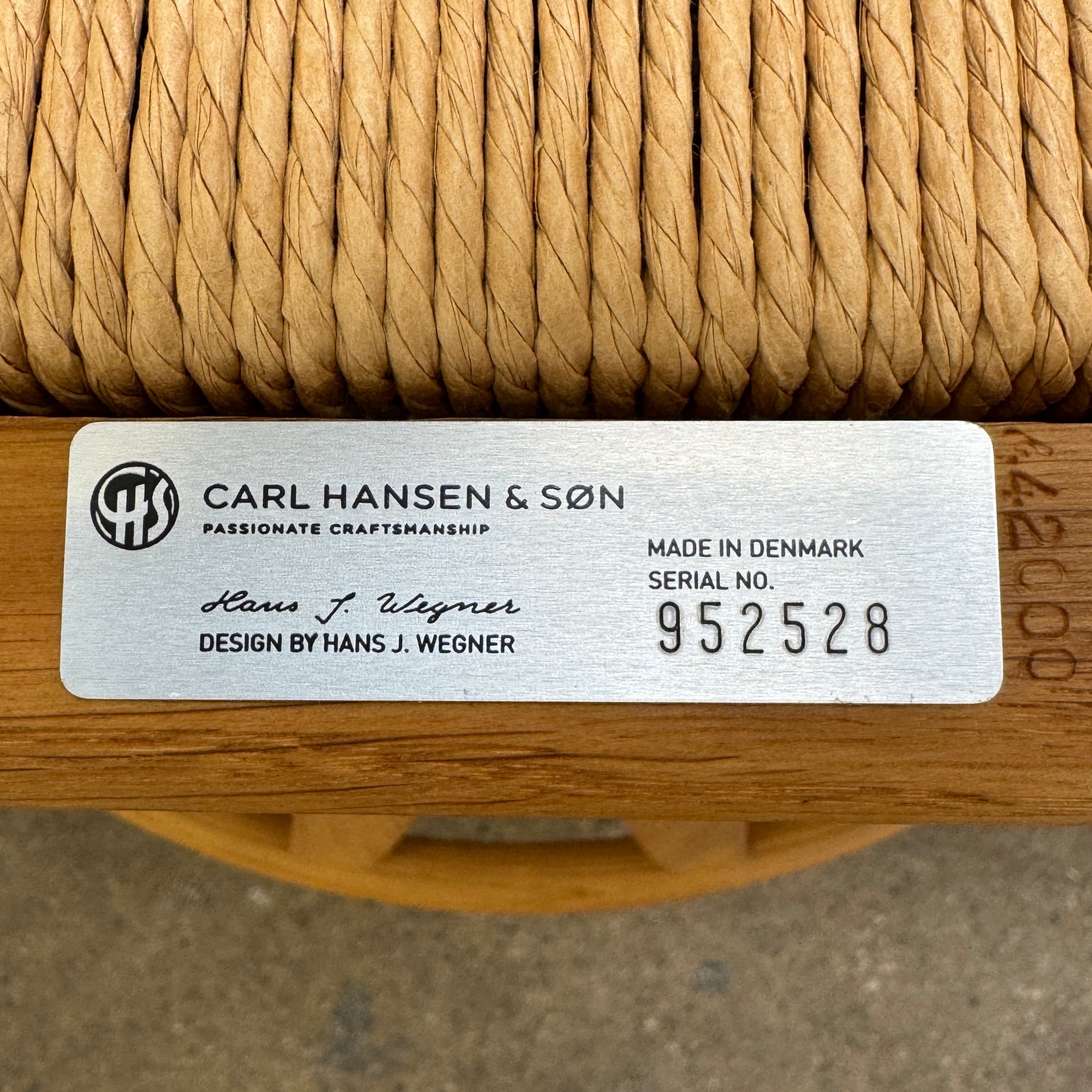 A set of two Carl Hansen & Søn Wishbone Dining Chairs by Carl Hansen & Son, featuring curved backrests and woven seats, are displayed side by side against a plain white background to highlight the renowned Danish craftsmanship inspired by Hans Wegner’s iconic design.