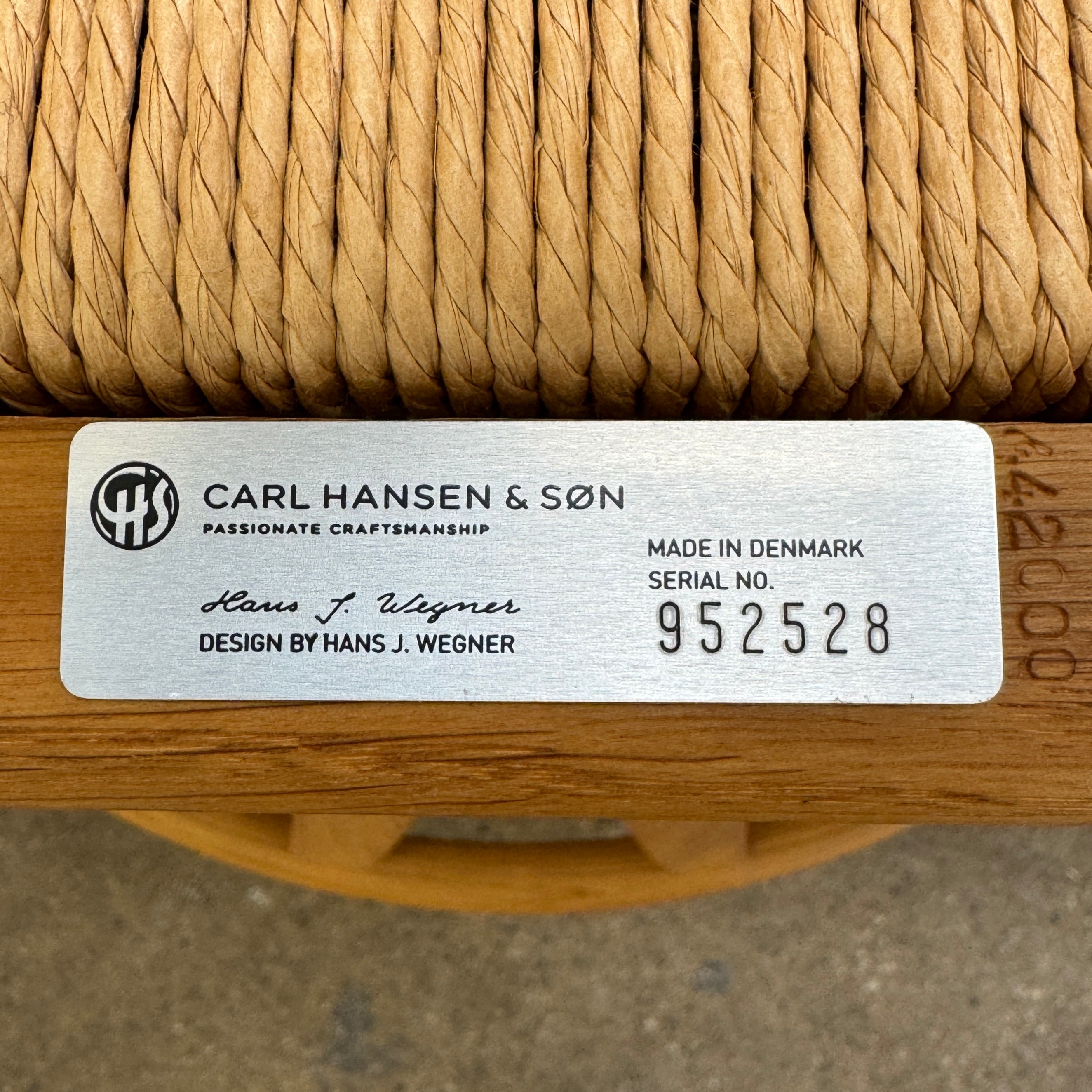 A set of two Carl Hansen & Søn Wishbone Dining Chairs by Carl Hansen & Son, featuring curved backrests and woven seats, are displayed side by side against a plain white background to highlight the renowned Danish craftsmanship inspired by Hans Wegner’s iconic design.
