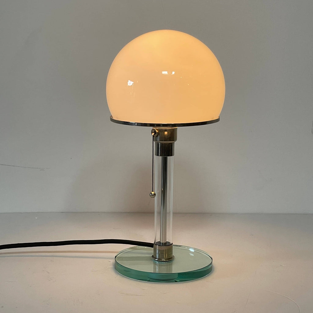 A TechnoLumen Bauhaus table lamp with a glass globe on top.