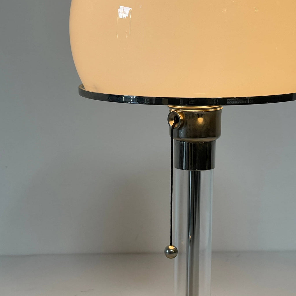 A TechnoLumen Bauhaus table lamp with a glass globe on top.