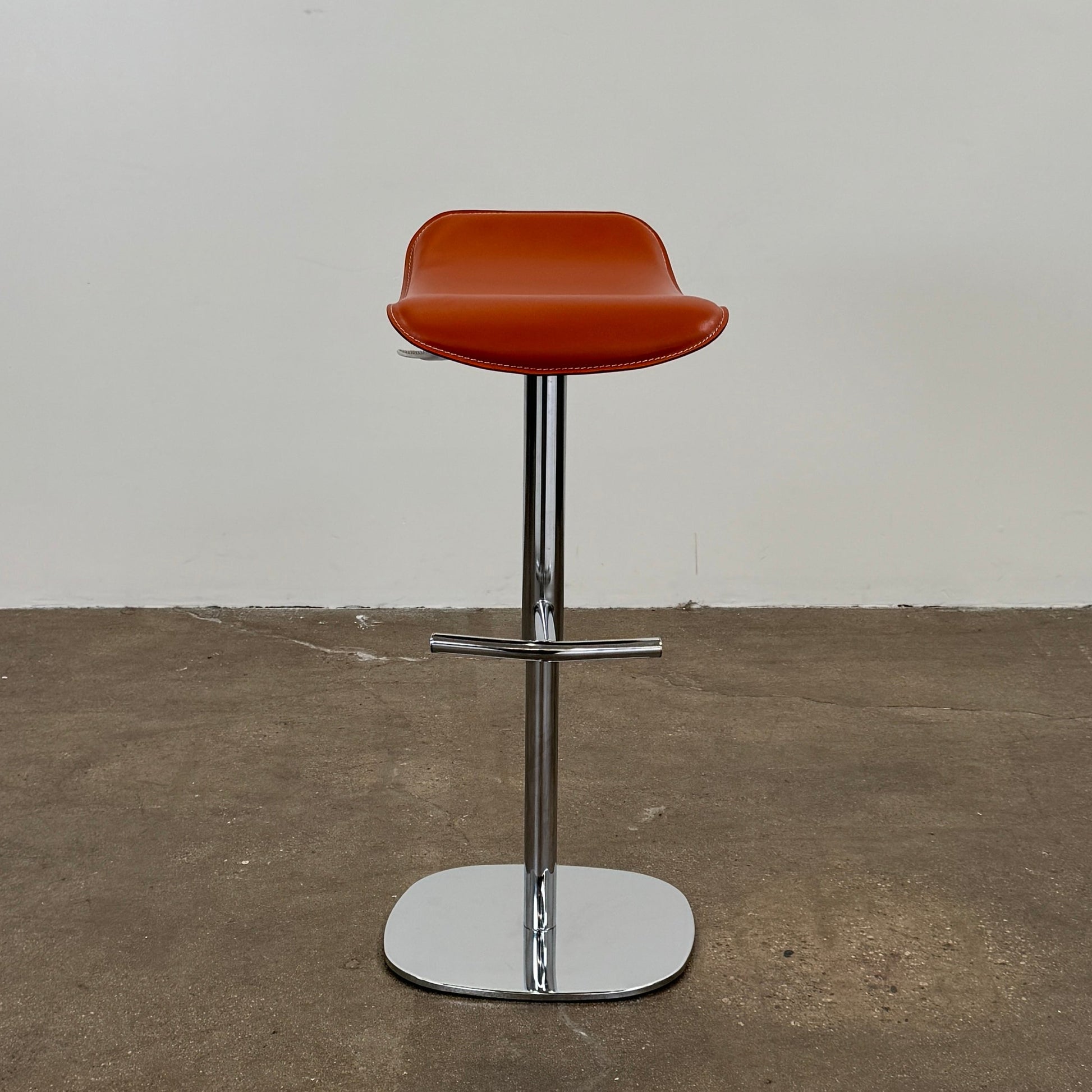 A set of three Giorgetti Ode Pneumatic Stools, featuring rich red-brown seats and sleek chrome bases, by luxury brand Giorgetti, are arranged in a row against a plain white background—exemplifying the refined elegance of Italian furniture design.