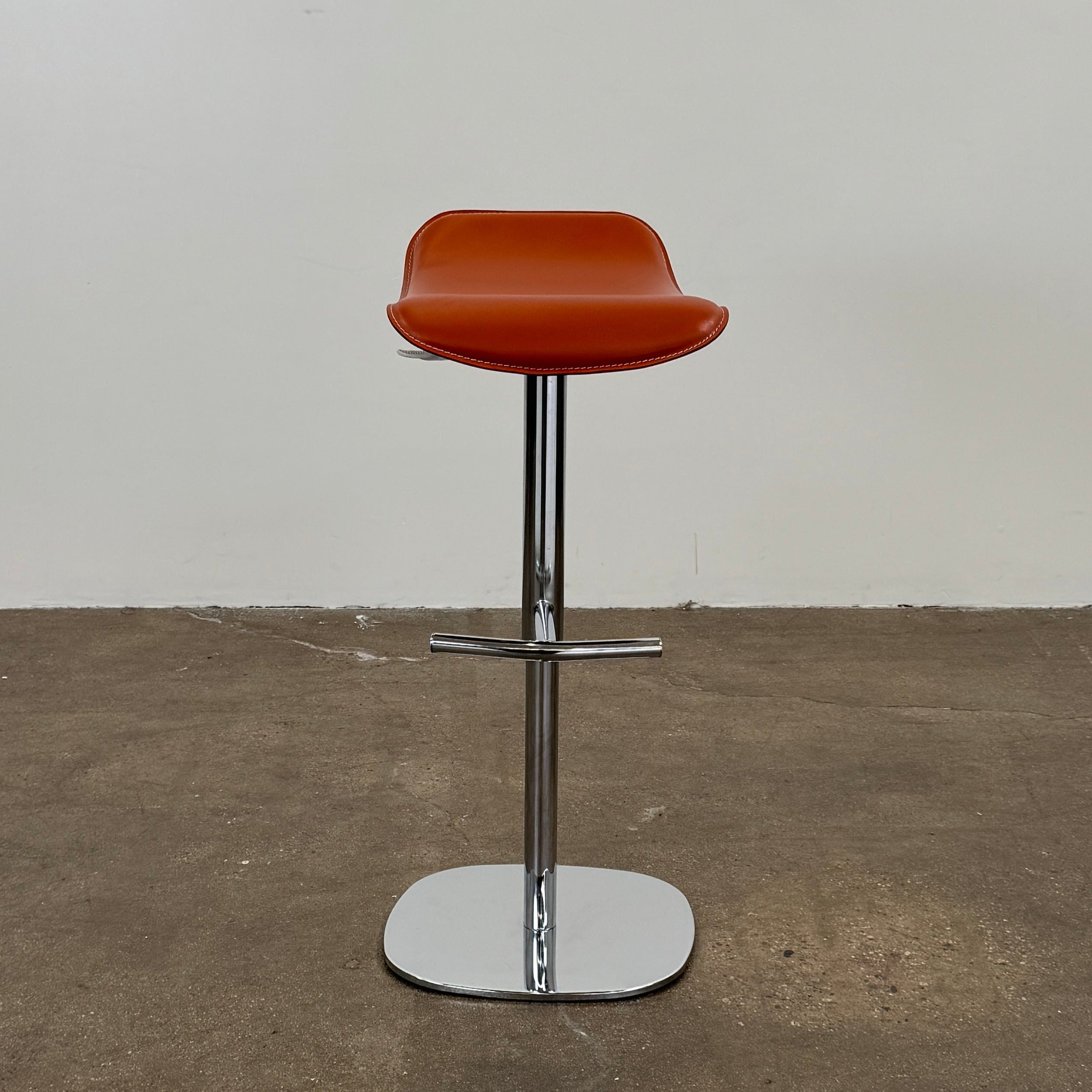 A set of three Giorgetti Ode Pneumatic Stools, featuring rich red-brown seats and sleek chrome bases, by luxury brand Giorgetti, are arranged in a row against a plain white background—exemplifying the refined elegance of Italian furniture design.