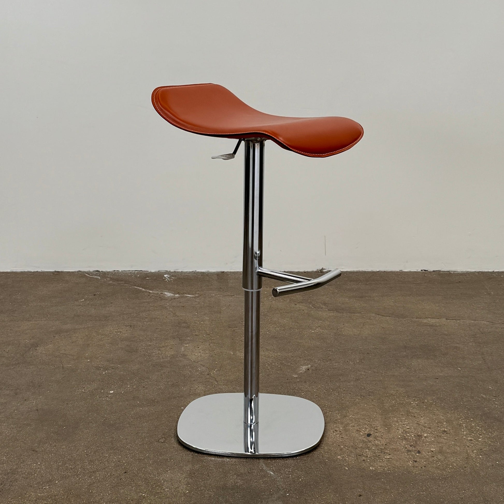 A set of three Giorgetti Ode Pneumatic Stools, featuring rich red-brown seats and sleek chrome bases, by luxury brand Giorgetti, are arranged in a row against a plain white background—exemplifying the refined elegance of Italian furniture design.