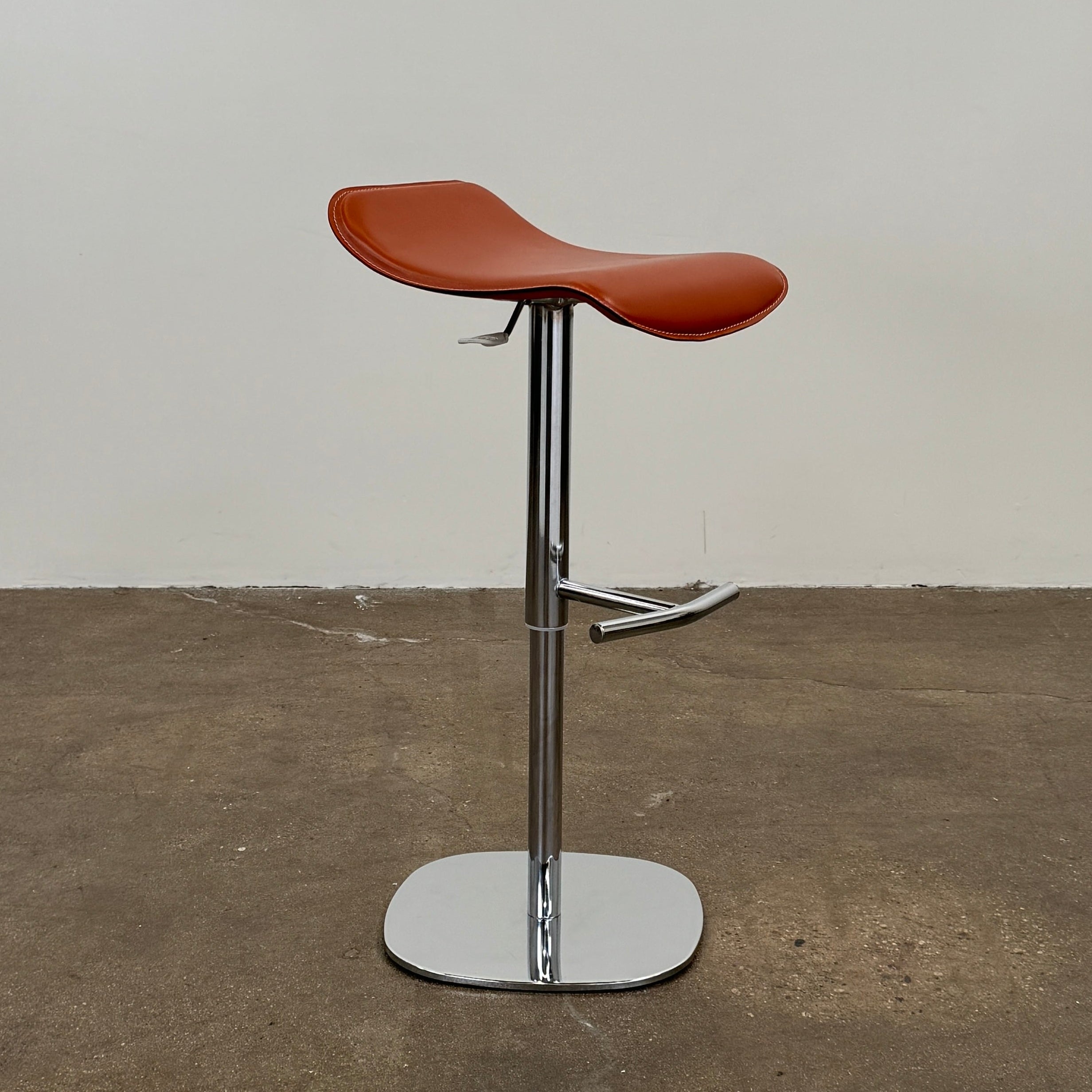 A set of three Giorgetti Ode Pneumatic Stools, featuring rich red-brown seats and sleek chrome bases, by luxury brand Giorgetti, are arranged in a row against a plain white background—exemplifying the refined elegance of Italian furniture design.