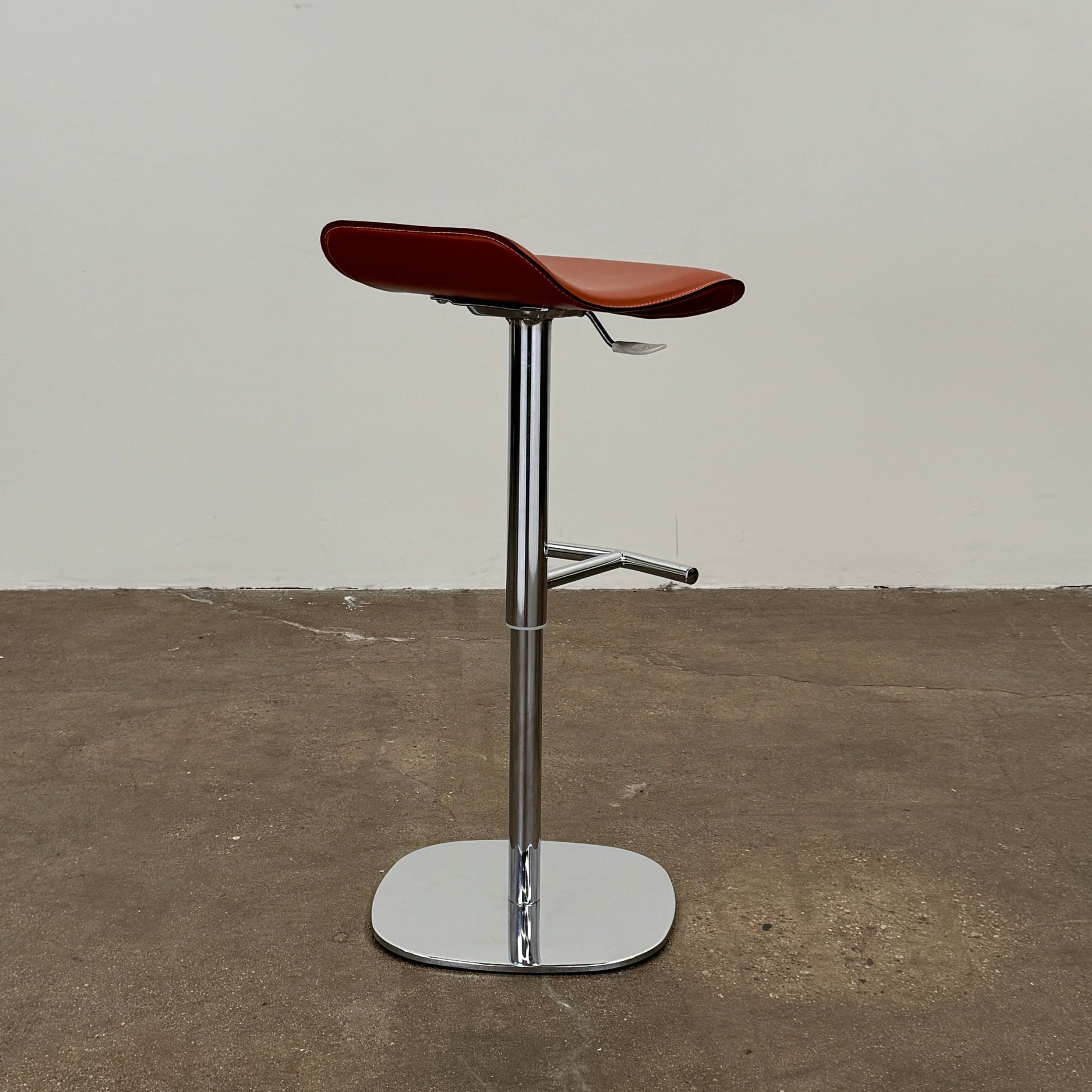 A set of three Giorgetti Ode Pneumatic Stools, featuring rich red-brown seats and sleek chrome bases, by luxury brand Giorgetti, are arranged in a row against a plain white background—exemplifying the refined elegance of Italian furniture design.