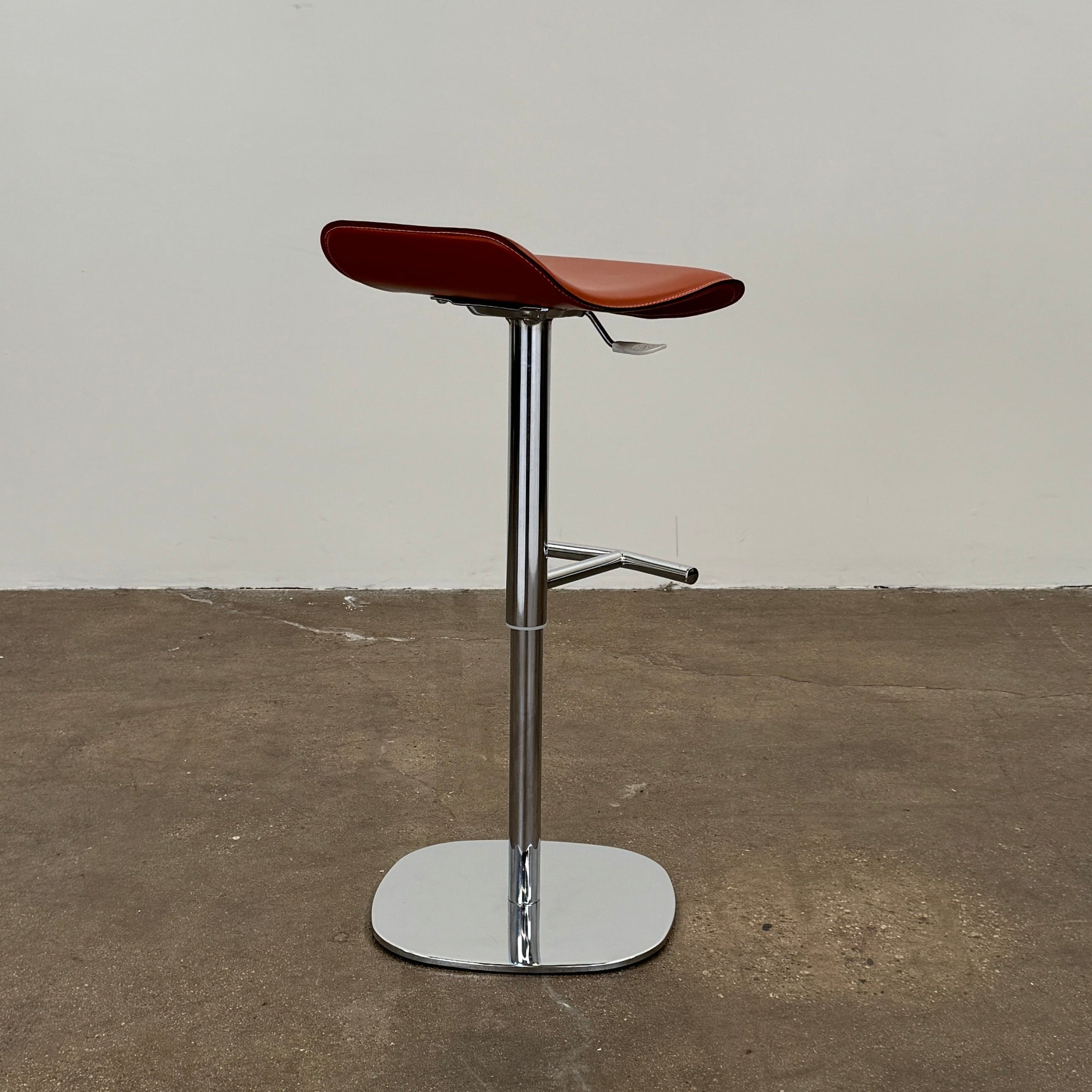 A set of three Giorgetti Ode Pneumatic Stools, featuring rich red-brown seats and sleek chrome bases, by luxury brand Giorgetti, are arranged in a row against a plain white background—exemplifying the refined elegance of Italian furniture design.