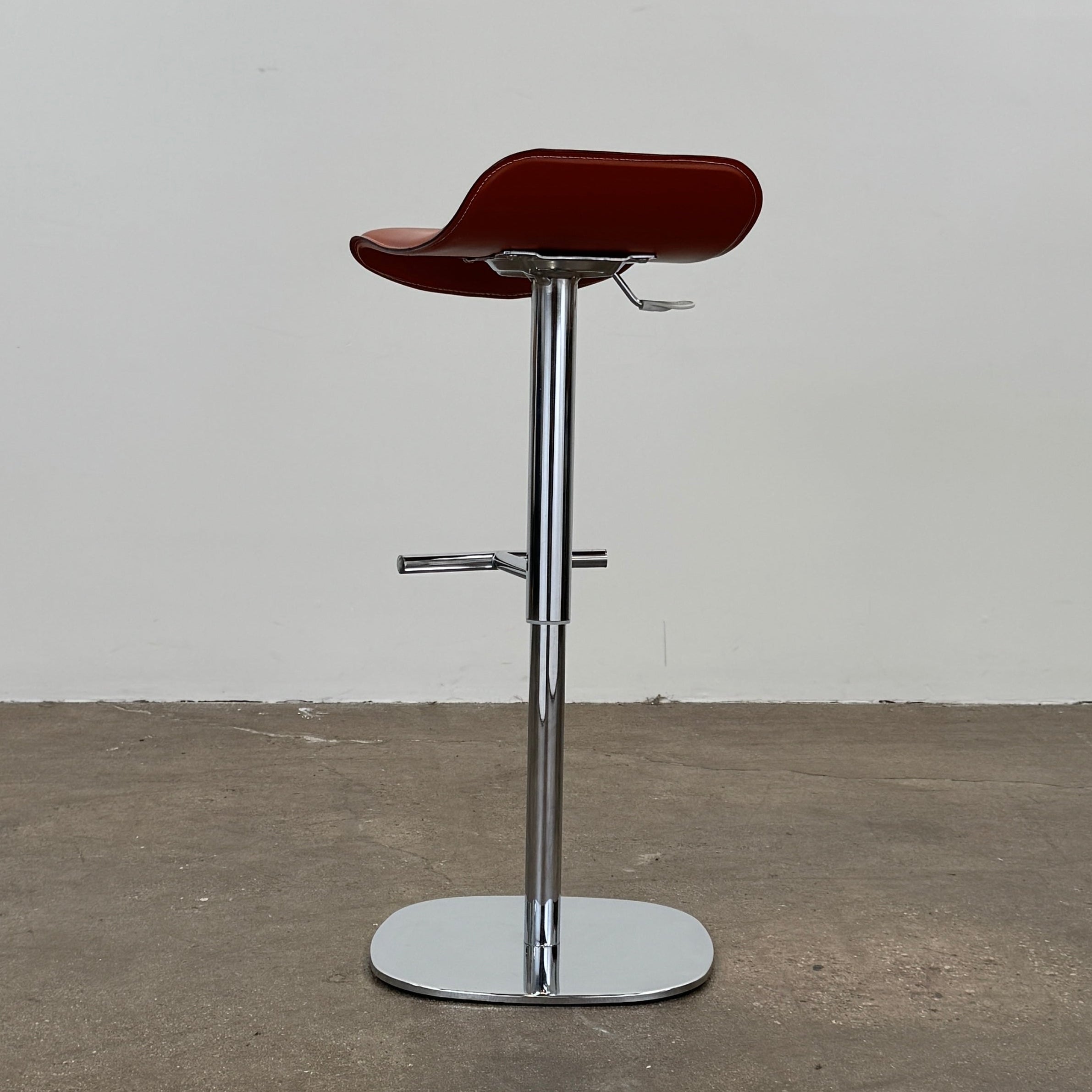 A set of three Giorgetti Ode Pneumatic Stools, featuring rich red-brown seats and sleek chrome bases, by luxury brand Giorgetti, are arranged in a row against a plain white background—exemplifying the refined elegance of Italian furniture design.