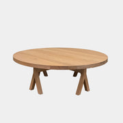 The De La Espada Commune Coffee Table 772, crafted by De La Espada from solid oiled oak, features a smooth round top and four angled legs. Displayed against a plain white background, it is ideal for enhancing communal living spaces.
