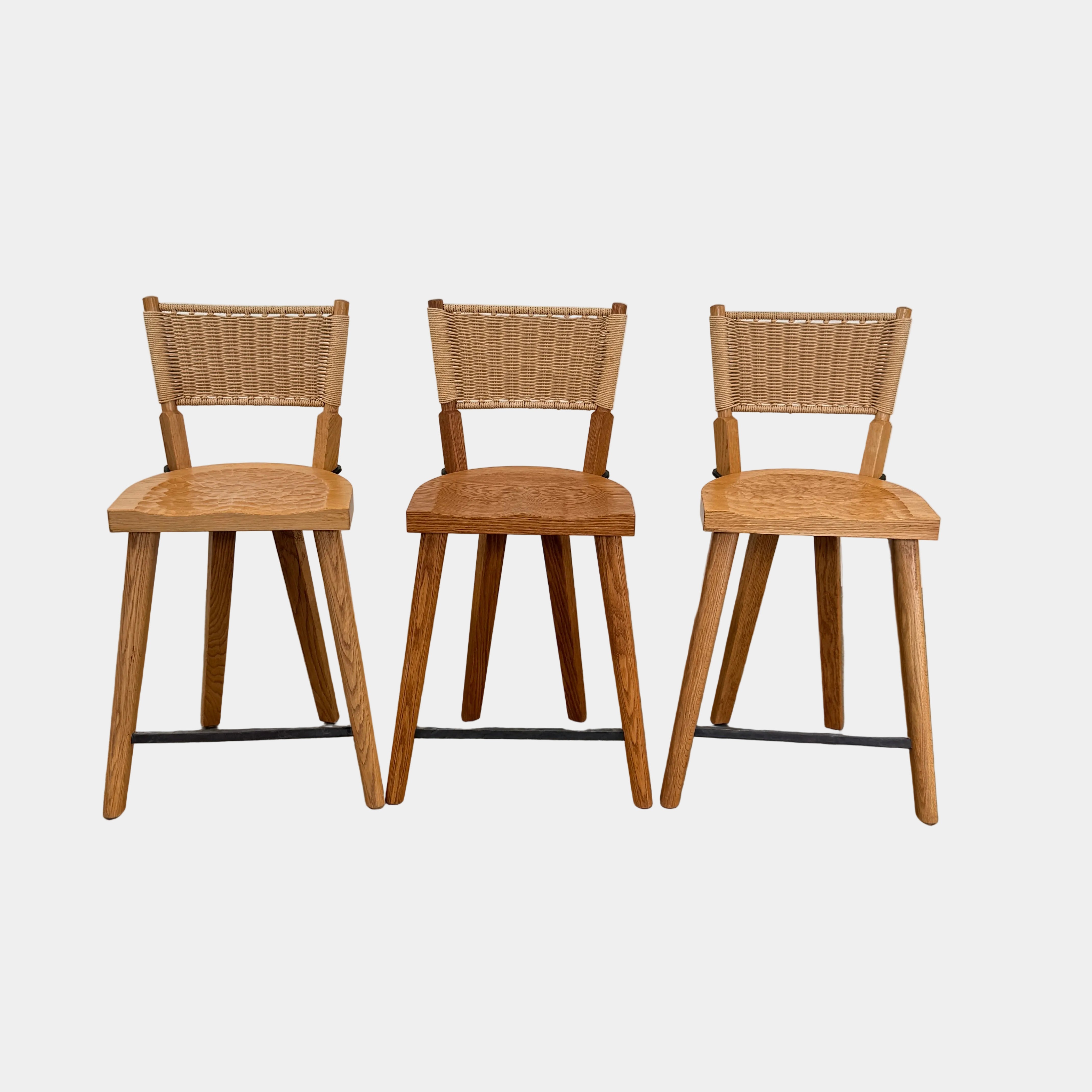 The Furniture Marolles Counter Stool Set of 3 by Furniture Marolles, featuring wooden construction and woven backrests inspired by handcrafted design, is arranged side by side against a plain white background.
